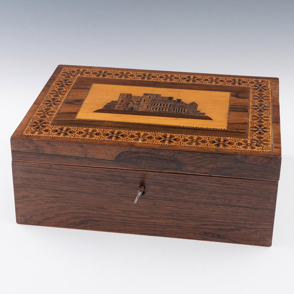 Heading : Tunbridge ware box with image of Tonbridge Castle

Date : c1840

Period : Victoria

Origin : Tonbridge or Brighton – see below.

Decoration : Central mosaic of Tonbridge castle with dentil stringing. Border with stylised floral banding and