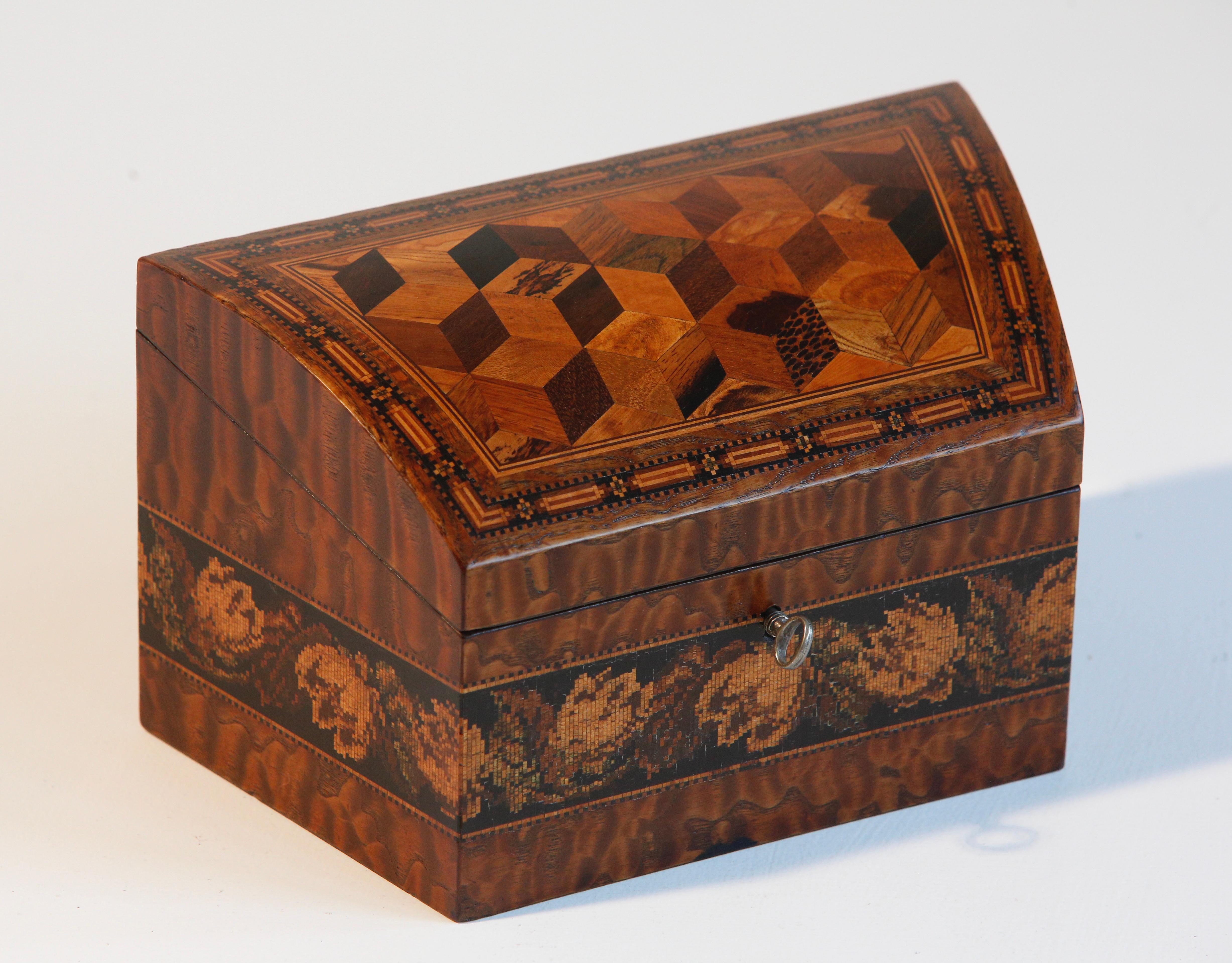 Mid 19th century Tunbridge ware stationery box by Edmund Nye, manufacturer.

The dome-shaped top is inlaid with a specimen parquetry panel, crossbanded with boxwood and stringing and Tunbridge ware borders. The lid is hinged and lifts up to reveal