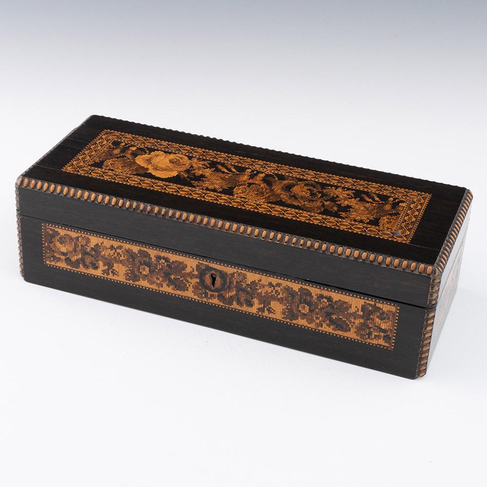 Heading : Tunbridge ware glove box attributed to George Wise Jr

Date : c1860

Period : Victoria

Origin : Probably Tonbridge, Kent

Decoration :  Central floral mosaic within a geometric border. Side panels each deocrated with floral mosaics.