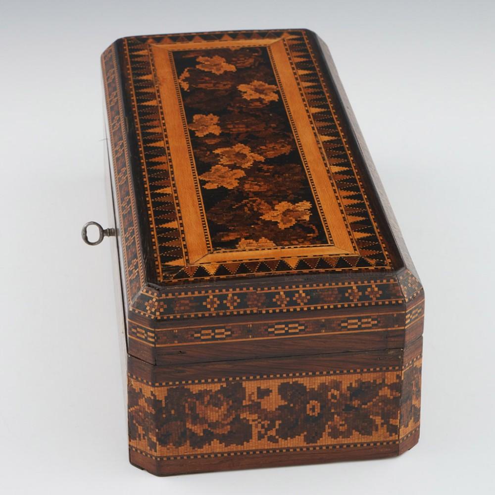Heading : Tunbridge ware glove box
Date : c1860
Period : Victoria
Origin : Tunbridge Wells, Kent
Decoration : Cover with a berlin woolwork floral mosaic within keylines bordered by vandyke triangles lined with keylines. The side panels of the cover