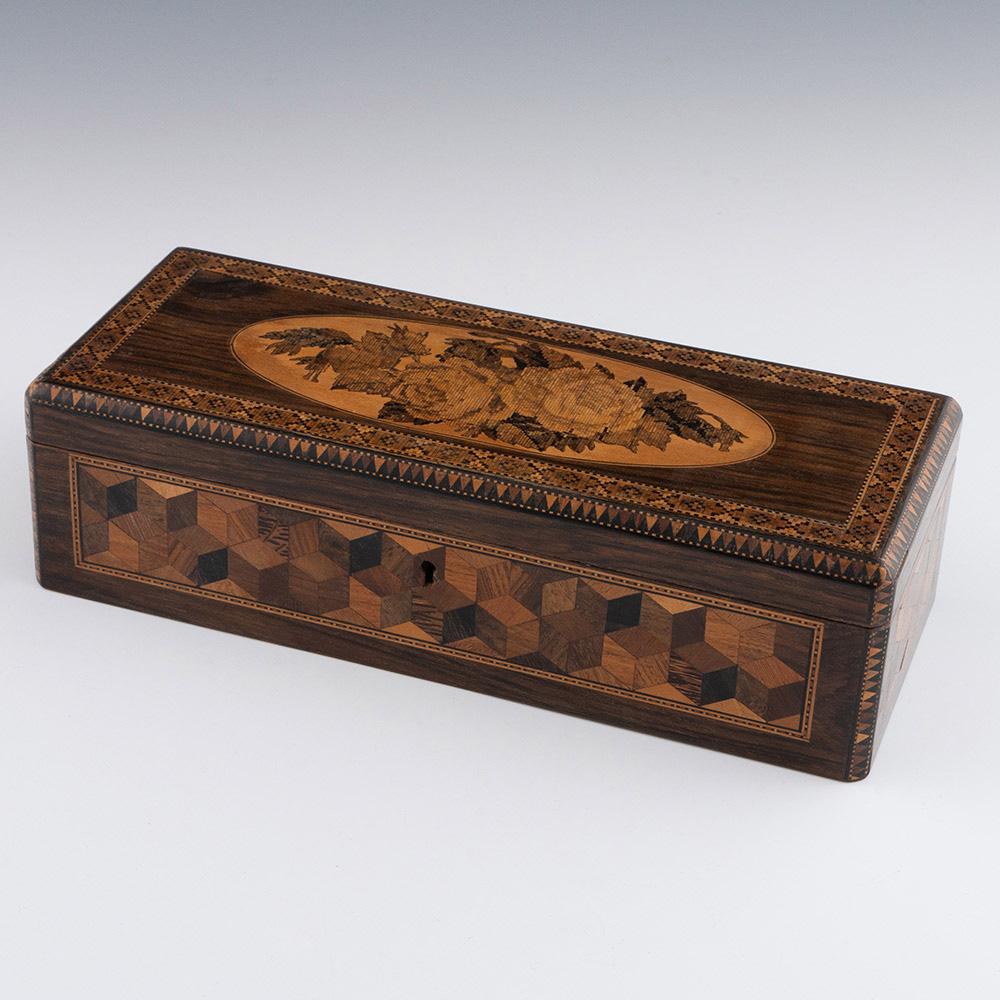 Heading : Tunbridge ware glove box – probably by George Wise

Date : c1860

Period : Victoria

Origin :  Tonbridge, Kent

Decoration : Central floral mosaic to the cover with geometric border. Side panels decorated with perspective cubes and van