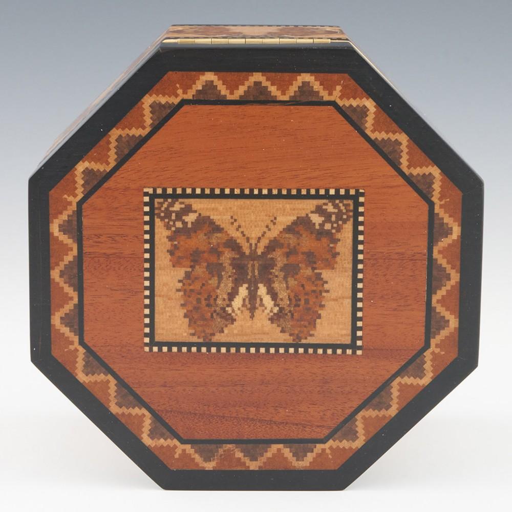 Heading : Tunbridge ware jewellery box
Date : 2022
Period : Elizabeth II
Origin : Essex
Decoration : Central tessellated mosaic of a Painted Lady butterfly within keylines. Geometric border. Side panels with a band of Painted Ladies within keylines.