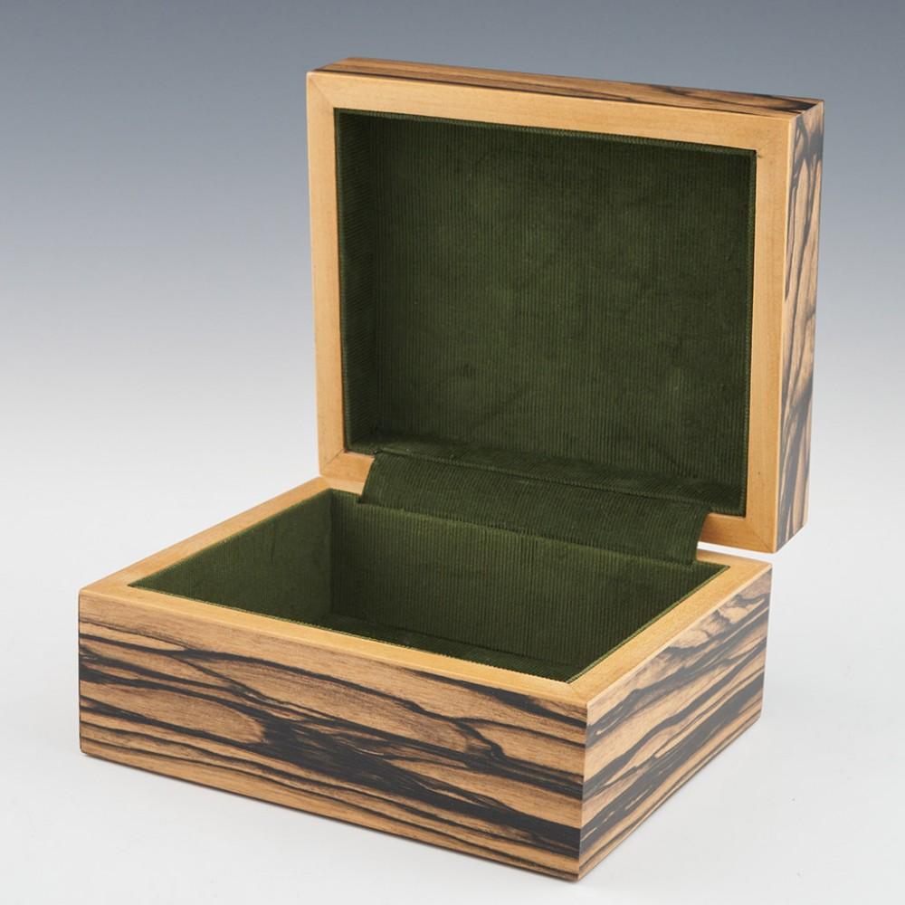 Heading : Tunbridge ware jewellery box by Robert Vorley
Date : 2023
Period : Charles III
Origin : Essex
Decoration : Perspective cube pattern to the cover within keylines. Geometric border. The box consists of 9 different woods on a white ebony