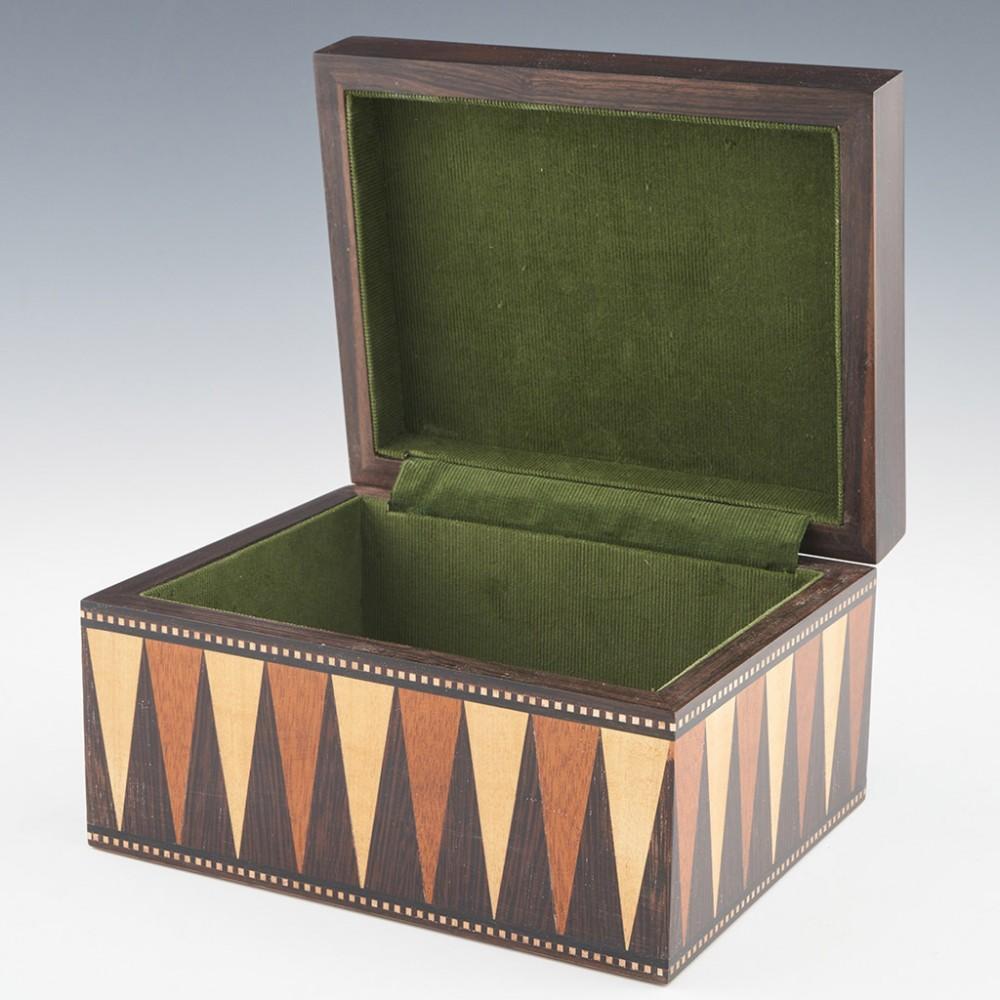 Heading : Tunbridge ware jewellery box
Date : 2023
Period : Charles III
Origin : Essex
Decoration : Perspective cube patterned cover with polychrome vandyke triangles to side panels with keyline border. Vorley utilised 9 different woodsmounted on an