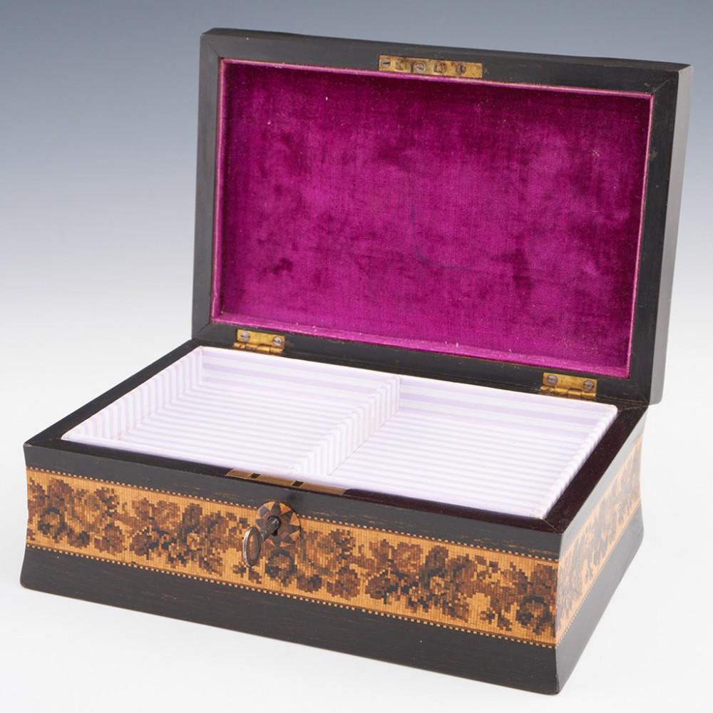 Heading : Tunbridge ware jewellery box
Date : c1870
Period : Victoria
Origin : Tunbridge Wells, Kent
Decoration : Pillow top cover with central floral mosaic within keylines. Cover bordered by foliate band within keylines. Side panels also decorated