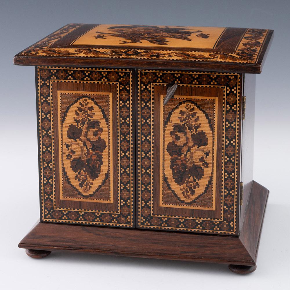 Heading : Tunbridge ware jewellery cabinet with floral mosaic

Date : c1870

Period : Victoria

Origin : Tunbridge Wells, Kent

Decoration : Floral mosaic to cover with stylised floral border within dentil strining. Front panels with floral mosaics