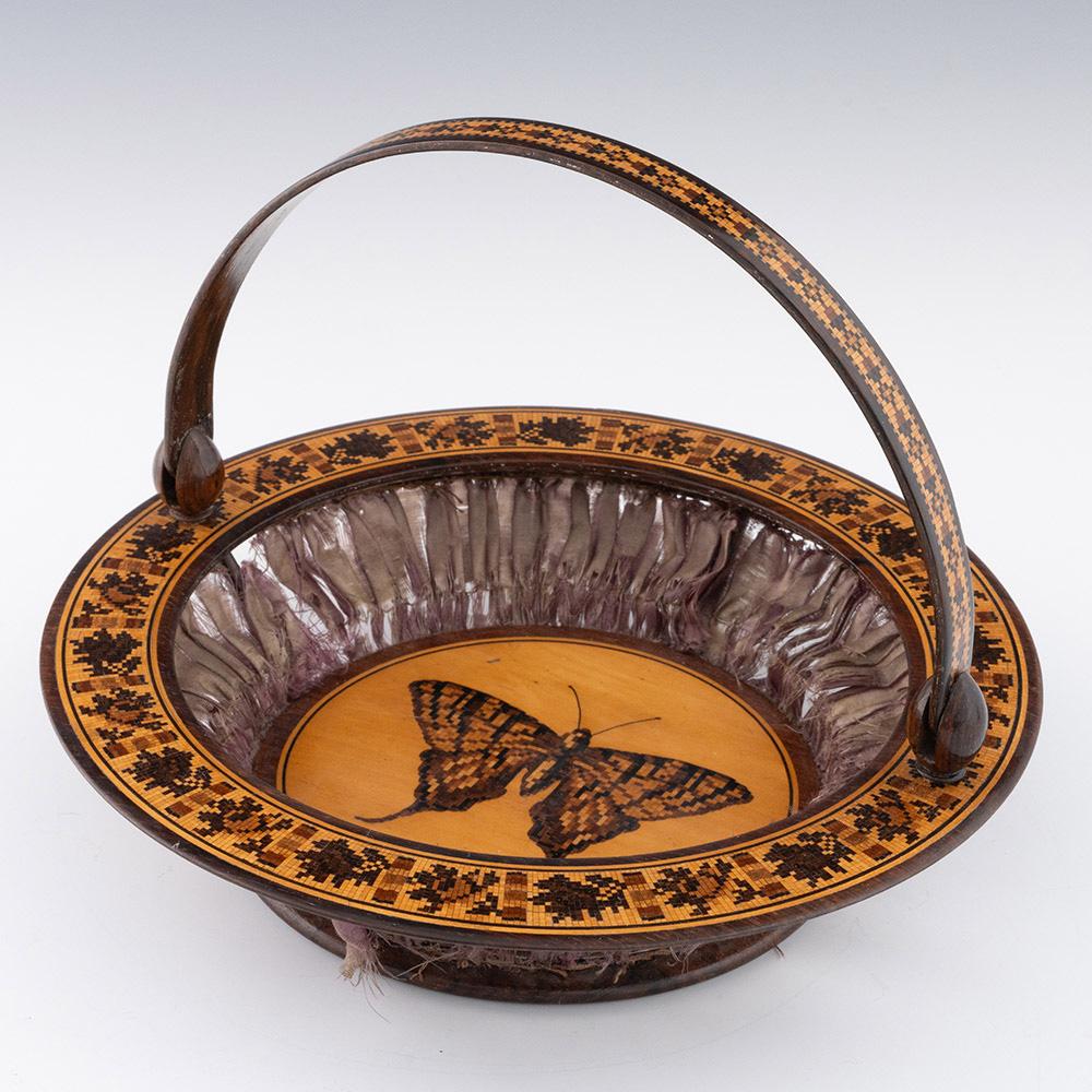 Intitulé : Panier à couture en porcelaine de Tunbridge par Edmund Nye vers 1860

Date : c1860

Période : Victoria

Origine : Tunbridge Wells, Kent

Décoration : Mosaïque centrale d'un papillon avec des détails à la plume. Doublure en soie. Bordure