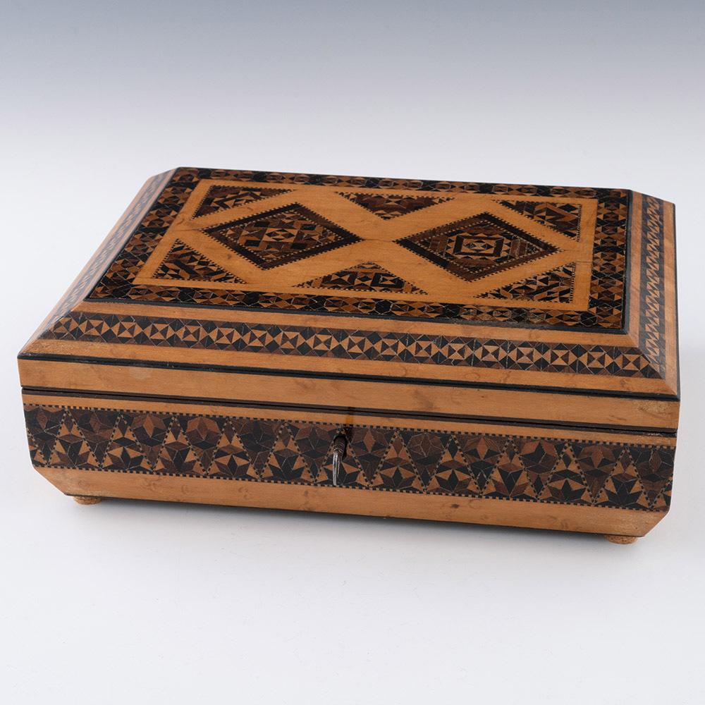 Heading : Tunbridge ware sewing box with geometric stickware

Date : c1840

Period : Victoria

Origin : Probably Tonbridge or Tunbridge Wells, Kent

Decoration : Central diamond panels of stickeware decoration with dentil stringin. Border with