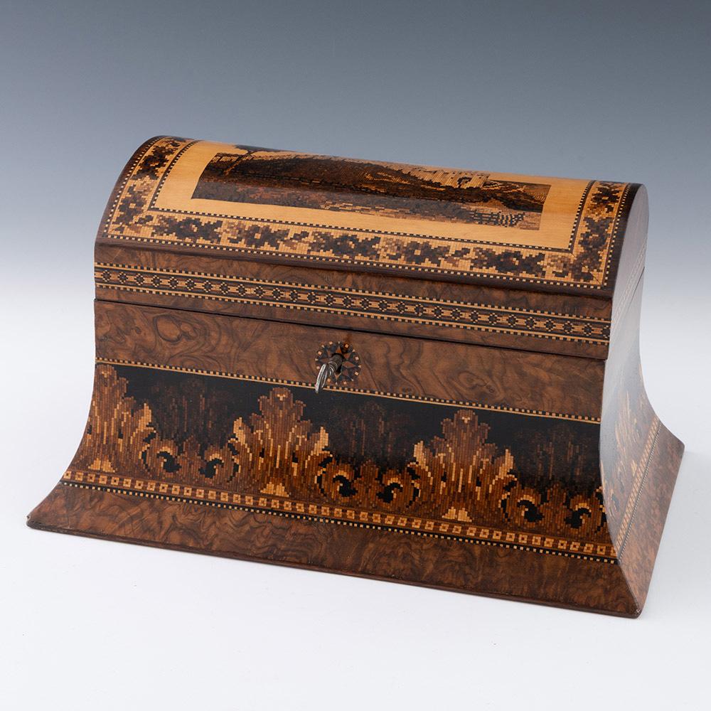 Heading : Tunbridge ware stationery box with image of Dover Castle

Date : c1870

Period : Victoria

Origin : Tunbridge Wells, Kent

Decoration : Central mosaic of Dover Castele with dentil strinigng and foliate border. Side panels of cover with