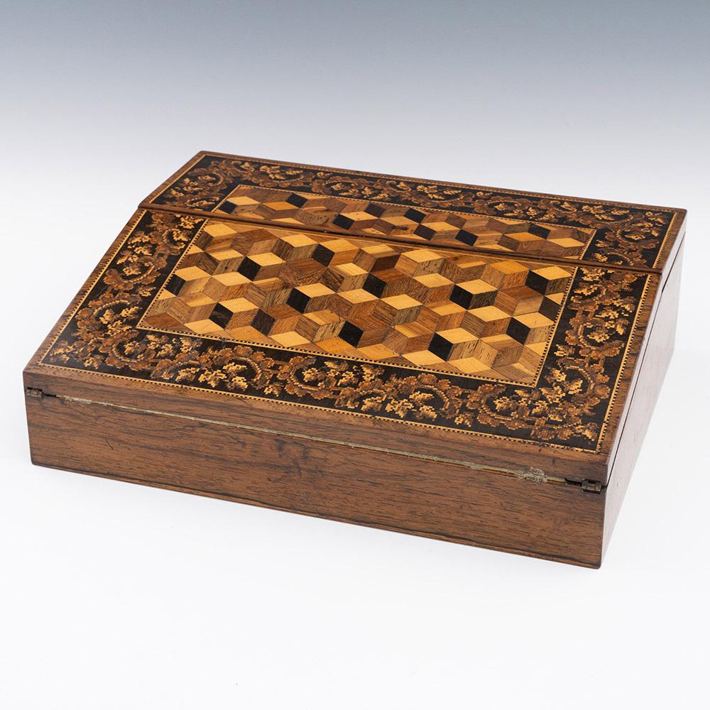 Heading :Tunbridge ware writing slope by William Upton c1860

Date : c1860

Period : Victoria

Origin : Brighton, East Sussex

Decoration : Central perspective cubework with foliate Berlin woolwork banding and dentil stringing. Interior with green