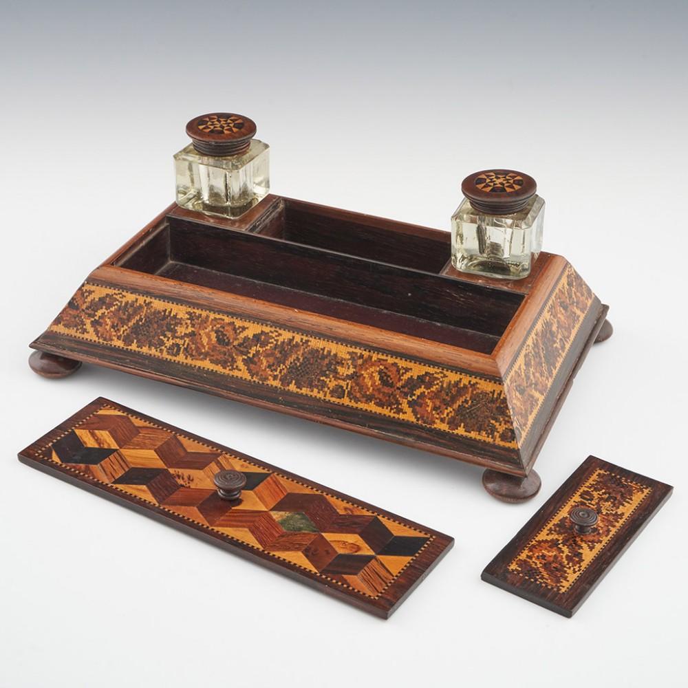 Heading : Tunbridge ware writing stand
Date : c1880
Period : Victoria
Origin : Tunbridge Wells, Kent
Decoration : The stand has two inkwells, each with geometric stickware covers, a pen tray with a perspective cube patterned cover with keylines and