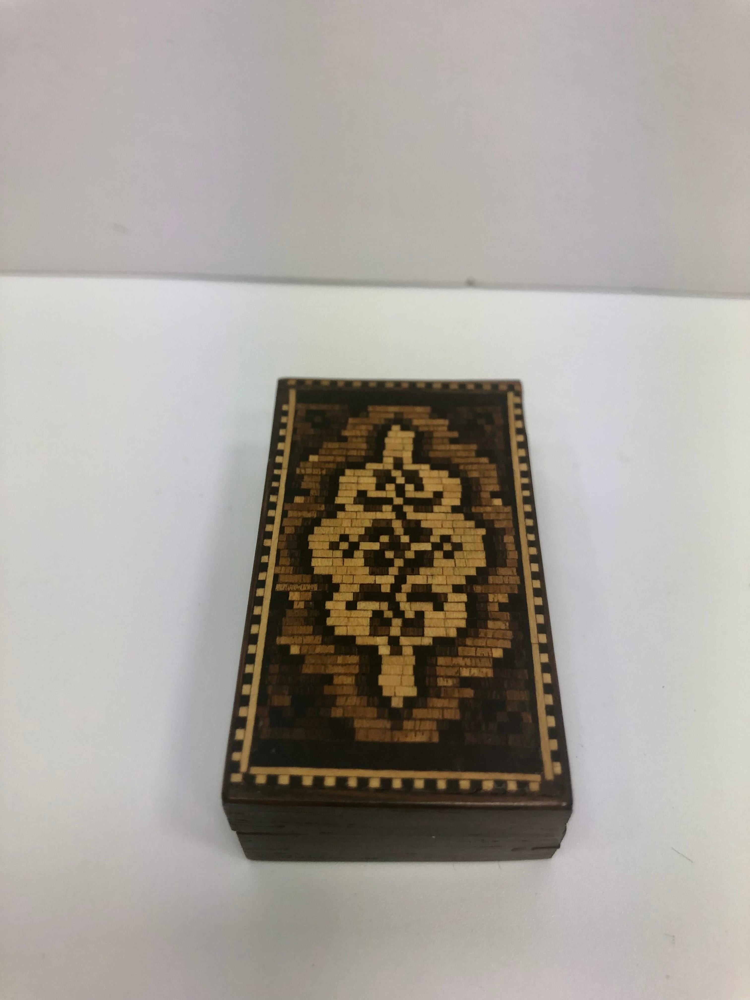 Tunbridge wooden trinket box made in England in the 1850s with an intricate design. Tunbridge wooden trinket box made in England in the 1850s. Tunbridge ware is a form of decoratively inlaid woodwork, typically in the form of boxes, that is