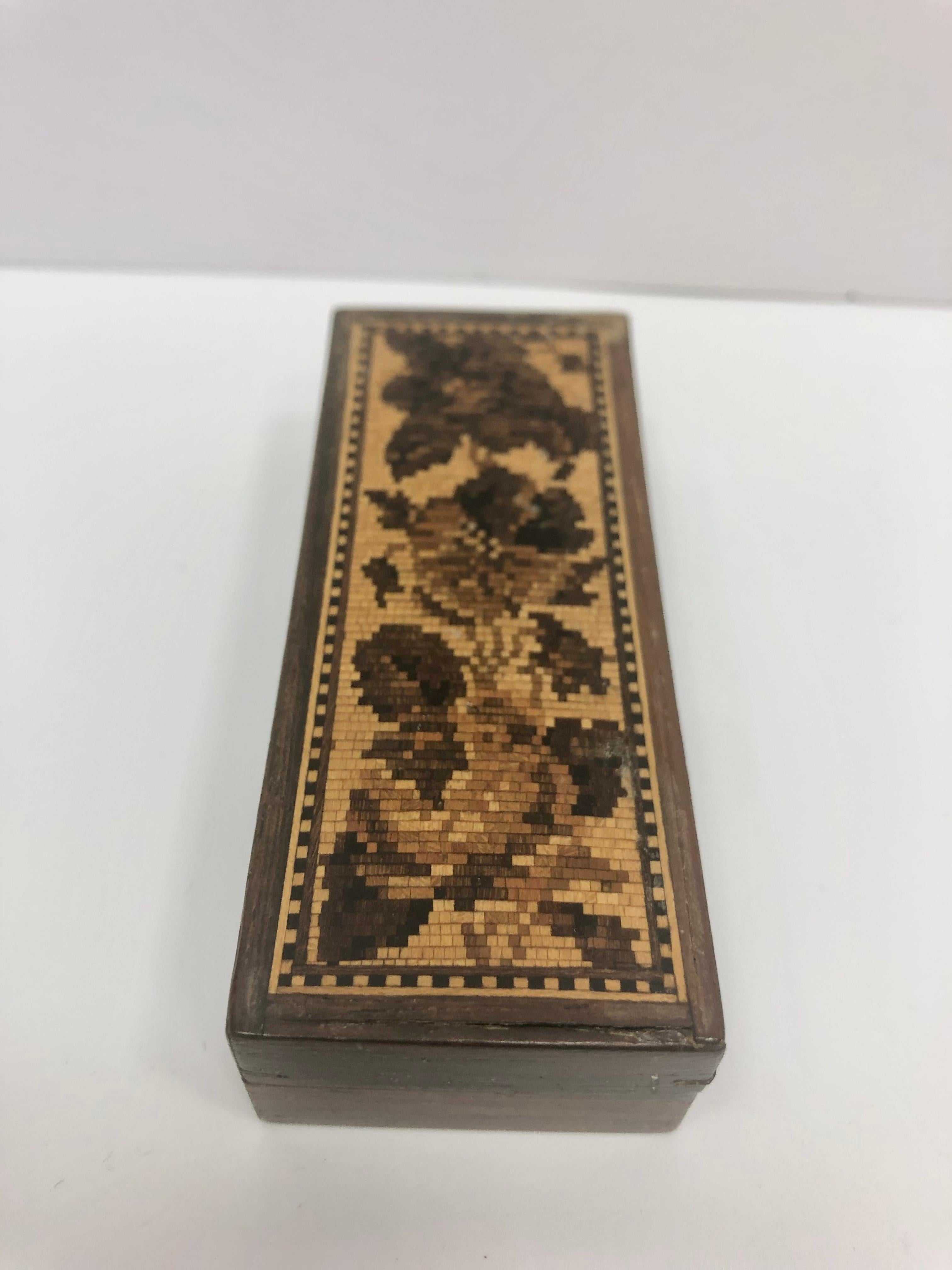 Tunbridge trinket box made in England in the 1870s. Wooden floral design. Tunbridge wooden trinket box made in England in the 1870s. Tunbridge ware is a form of decoratively inlaid woodwork, typically in the form of boxes, that is characteristic of