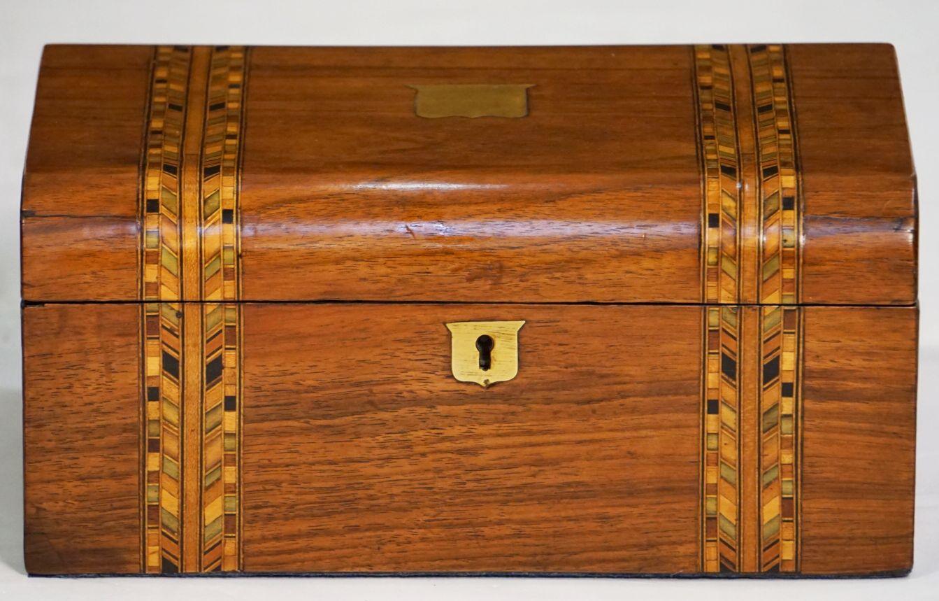 An English rectangular box from the 19th century, featuring an inlaid design of miscellaneous woods known to collectors as Tunbridgeware.

Exterior with a geometric pattern design of herringbone to the top and front. 
With brass inlay chevrons to
