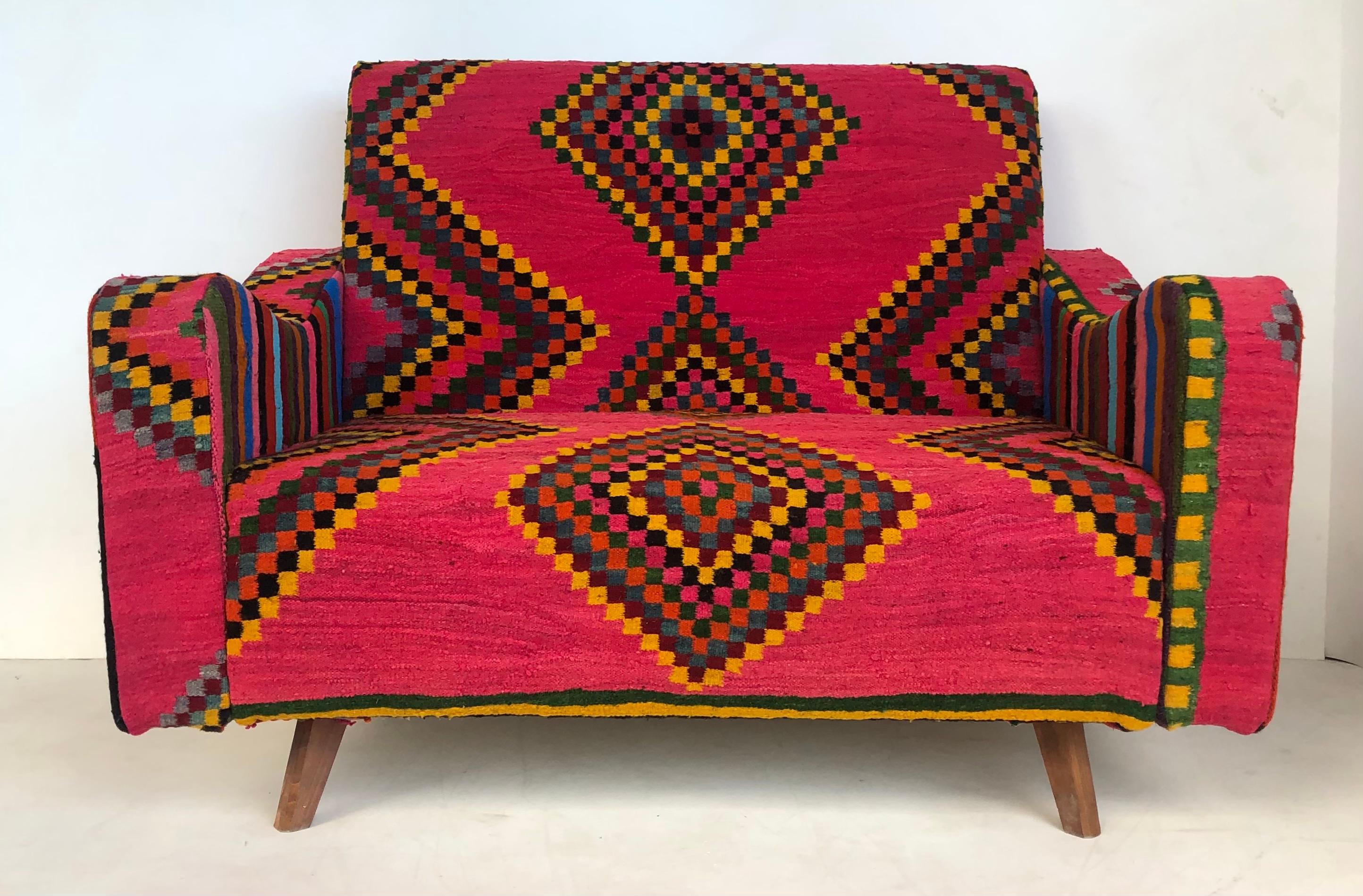 Tunisian (North Africa) woven wool textile loveseat with brightly colored fabric

Offered for sale is a Tunisian (North African) woven wool textile upholstered loveseat with angular, tapering conical legs. This brightly colored sofa is being