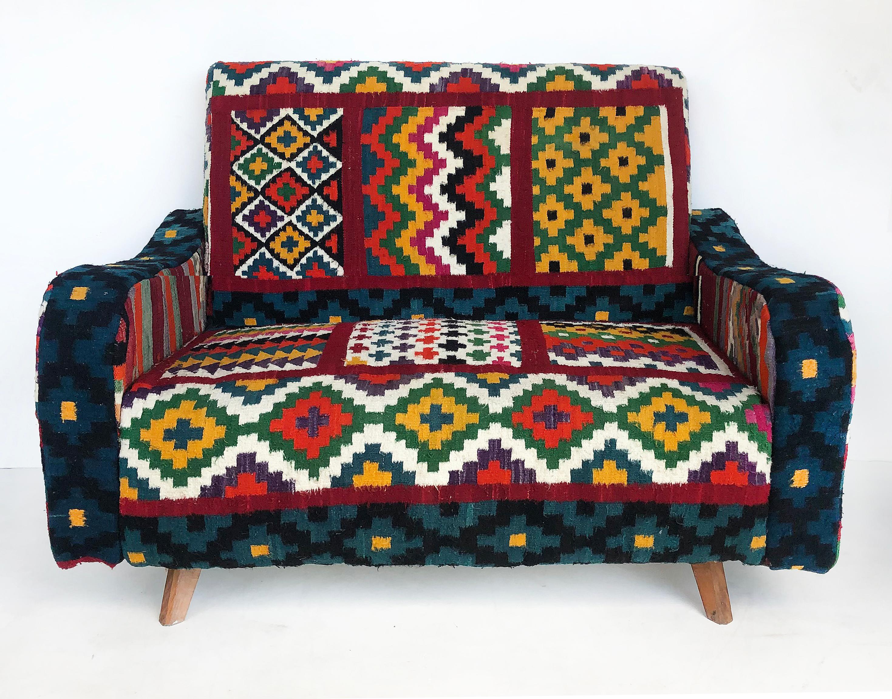 Tunisian (North Africa) Woven Wool Textile Loveseat with Brightly Colored Fabric

Offered for sale is a Tunisian (North African) woven wool textile upholstered loveseat with angular, tapering conical legs. This brightly colored sofa is being offered