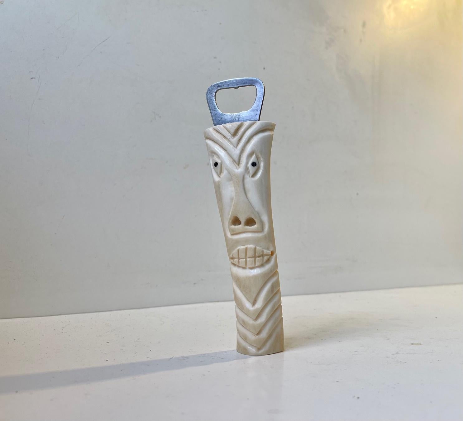 Décapsuleur figuratif sculpté à la main dans de l'os ou de la dent blanche. Fabriqué à la maison par un chasseur créatif au Groenland vers 1960-70. Dimensions : I.L.A. : 16,5 cm.