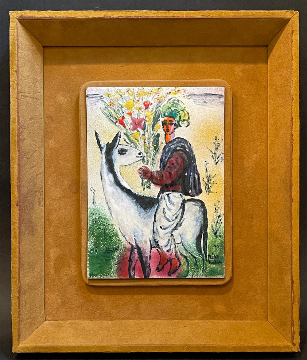 Ricamente empapado en colores vibrantes -verde bosque, rojo intenso, amarillo aciano, negro y blanco-, este panel de esmalte enmarcado representa a un hombre exótico con turbante, montado en una cabra y llevando un ramo de flores.  Aunque está
