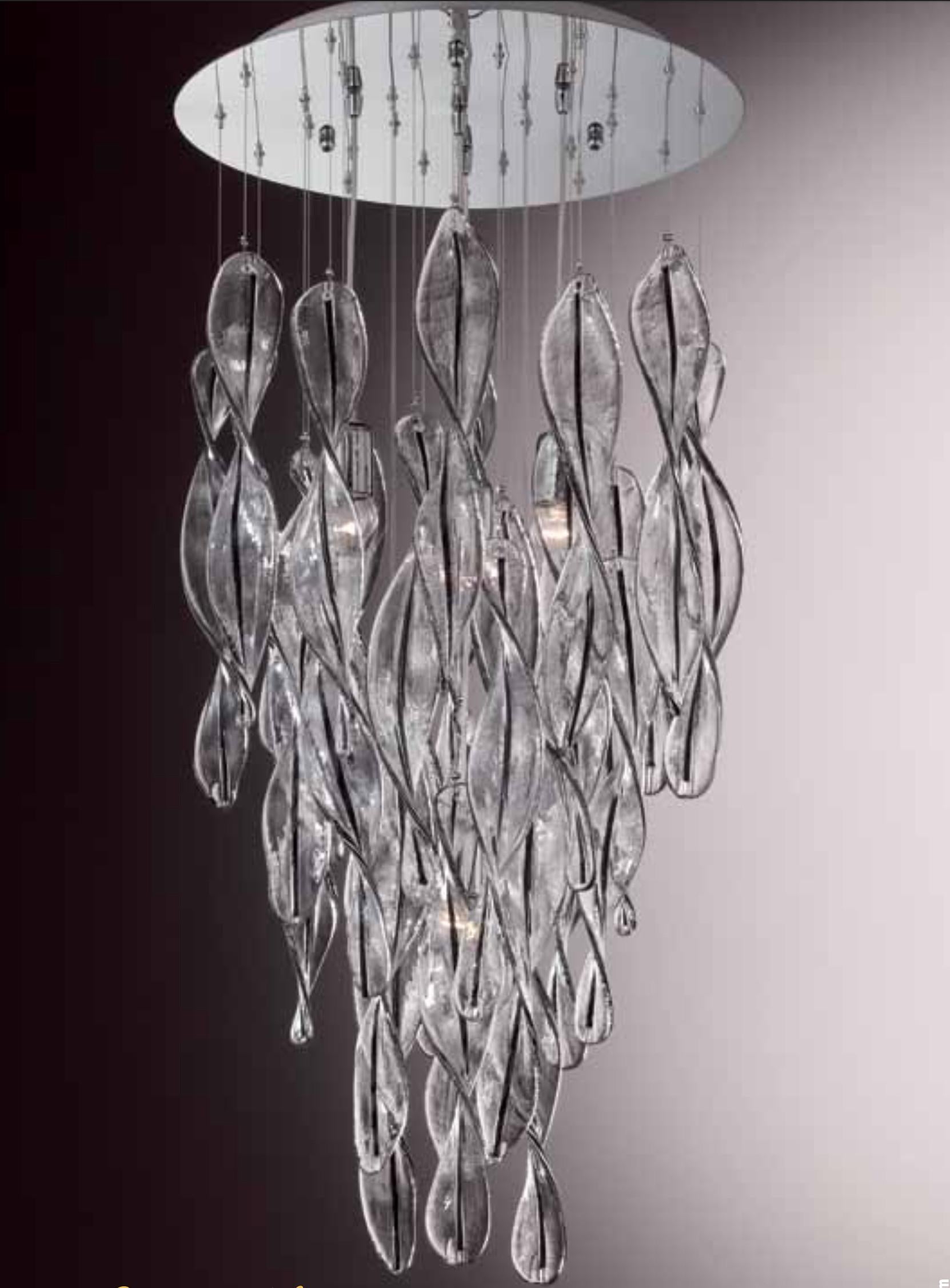 Italian flush mount shown with clear Murano glass swirls decorated with black stripes in the center, mounted on round stainless steel ceiling plate / inspired by Mazzega / Made in Italy
4 lights / E26 or E27 type / max 60W each
Measures: Diameter 20