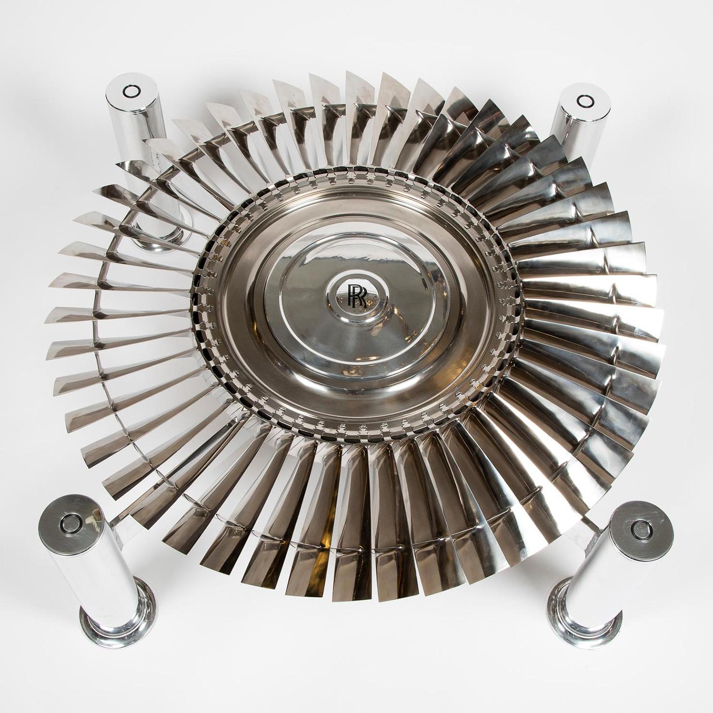 Coffee table Turbine Rolls Royce on polished aluminum base.
With rotating Rolls Royce turbine in titanium from the turbofan 
Pegasus fighter's engine. With strong clear glass top.
 