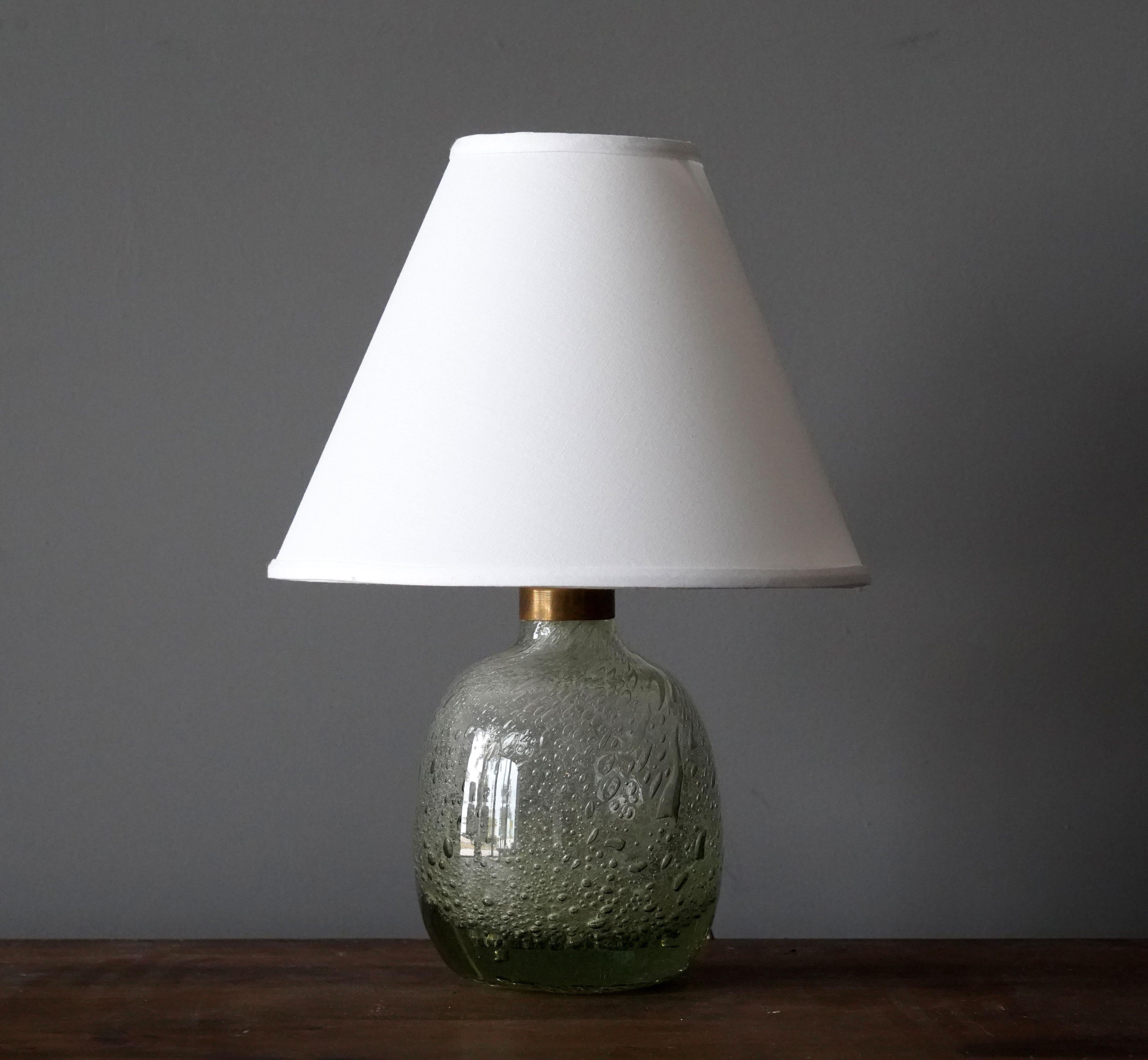 A table lamp by Ture Berglund, in brass and green colored studio glass. Produced by Stockholms Glasbruk, 1930s.

Sold without lampshade. Stated dimensions excluding lampshade.

Other lighting designers of the period include Hans-Agne Jacobson,