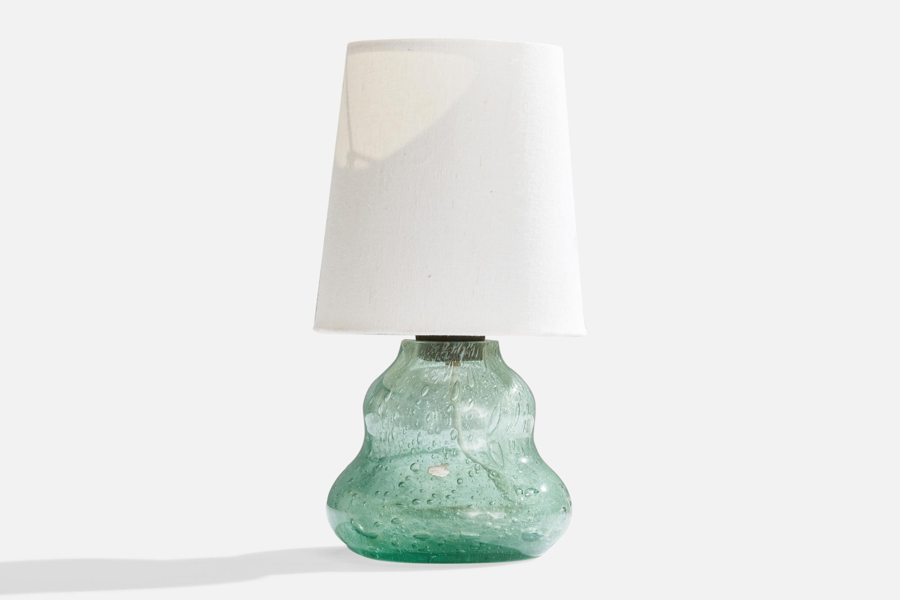 A blown glass and white fabric table lamp, designed by Ture Berglund and produced by Skansen, Glass, Sweden, c. 1940s.

Overall Dimensions (inches): 11.5”  H x 5.5”  D
Stated dimensions include shade.
Bulb Specifications: E-26 Bulb
Number of