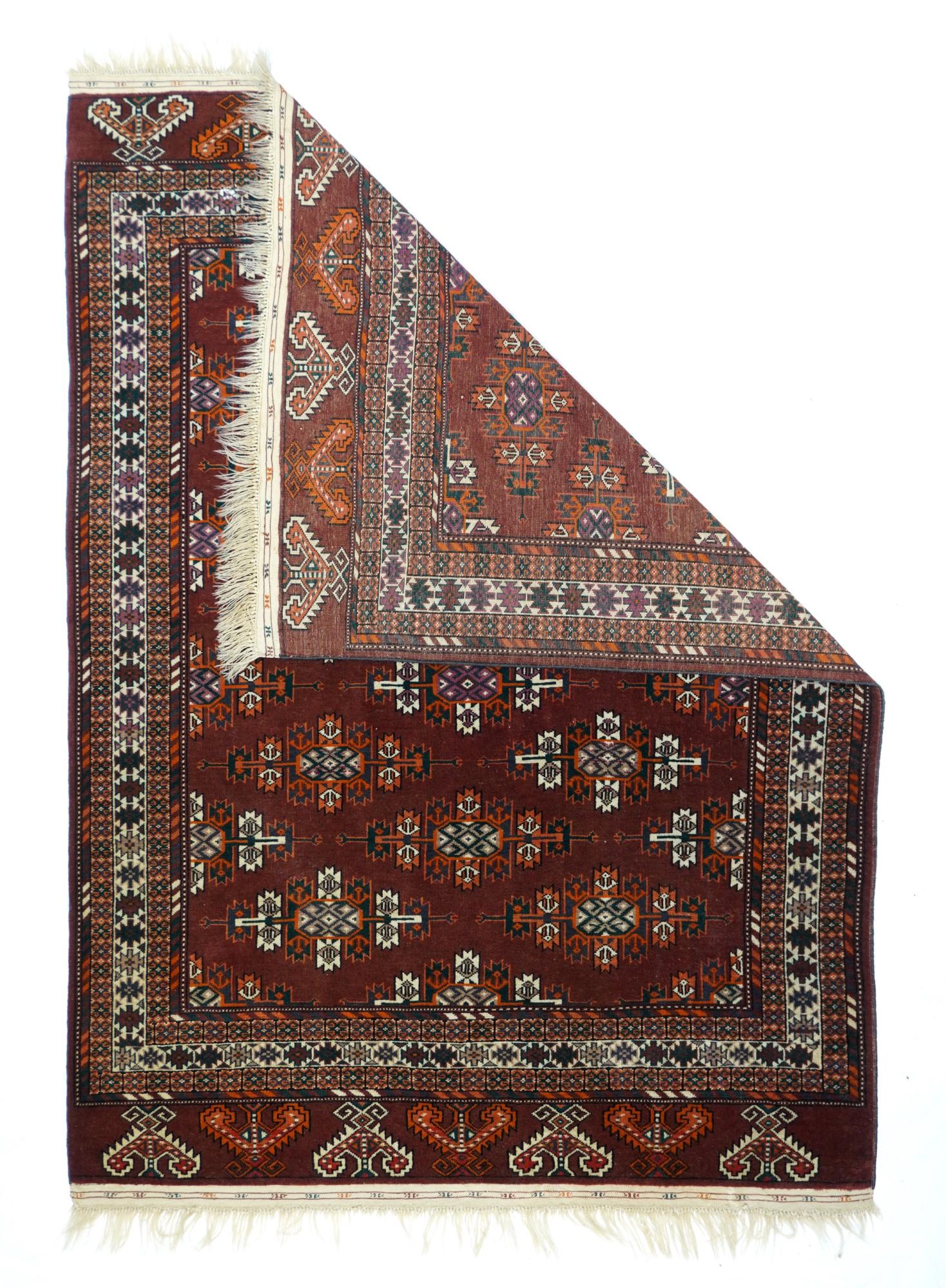 In the style of larger Yomud tribal main tent carpets, this nomadic scatter shows colour diagonals of Kepse emblematic guls in cream and red on the dark liver purple ground. Cream main border with chains of stepped rectangles. Liver-tone elems