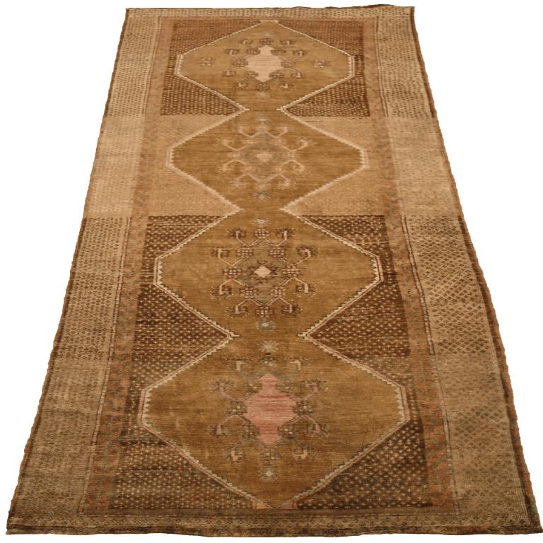 Traditional Turkish Wool Runner Rug

This extraordinary runner displays a captivating sequence of intricate geometric medallions, guiding the eye with its artful linearity. Its robust construction and subtly rich, antique palette provide a profound