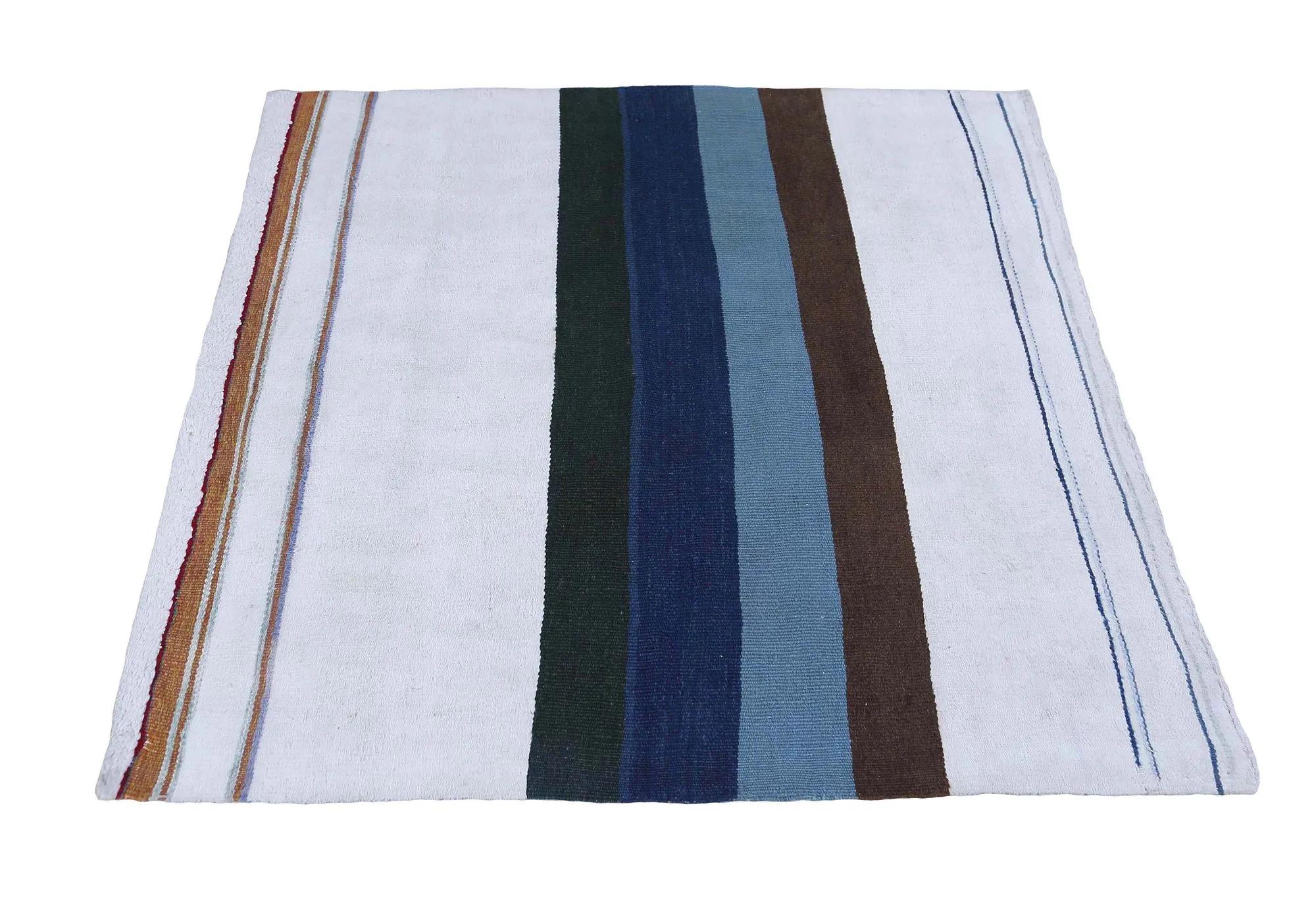A Modern Turkish Kilim Rug 

An Artistic Weave Unfolds
This magnificent Turkish Kilim, measuring 4 ft 2 in x 4 ft 3 in, stands as a stunning testament to centuries of celebrated Anatolian textile artistry. Its flat-woven surface reveals a