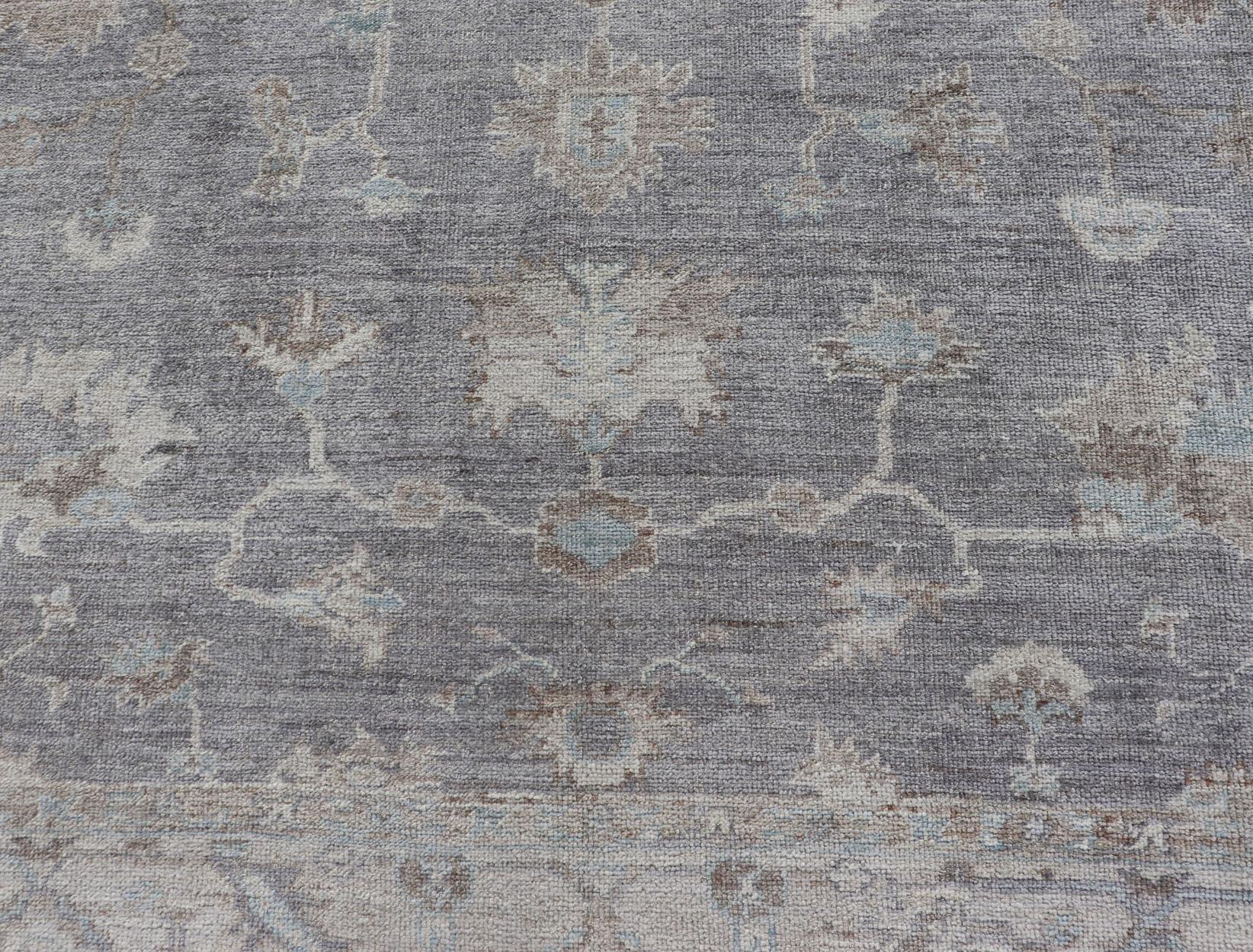 Measures: 8'2 x 9'8 

Turkish Angora Oushak Rug in Smoky Gray with Ivory, Taupe, 
Soft Blue 8'2 x 9'8. Keivan Woven Arts. rug /AN-148446/ Early 21st Century, Turkish Oushak.

This luxurious Turkish Angora Oushak rug is hand-knotted in a refined