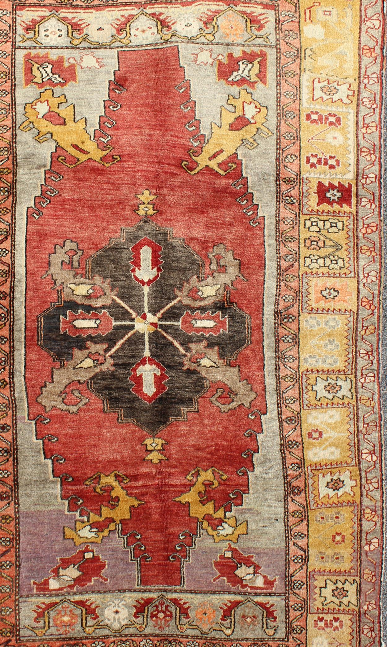 Measures: 4'8 x 8'7

This beautiful Turkish Oushak is unique in its color palette. The center medallion features a combination of black, brown, gold, red and light purple. The border has intense gold and yellow toned floral crests.

Country of