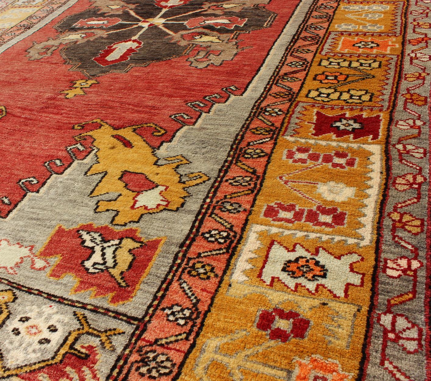 Wool Turkish Antique Tribal Diamond Medallion Oushak Area Rug in Red and Gold For Sale