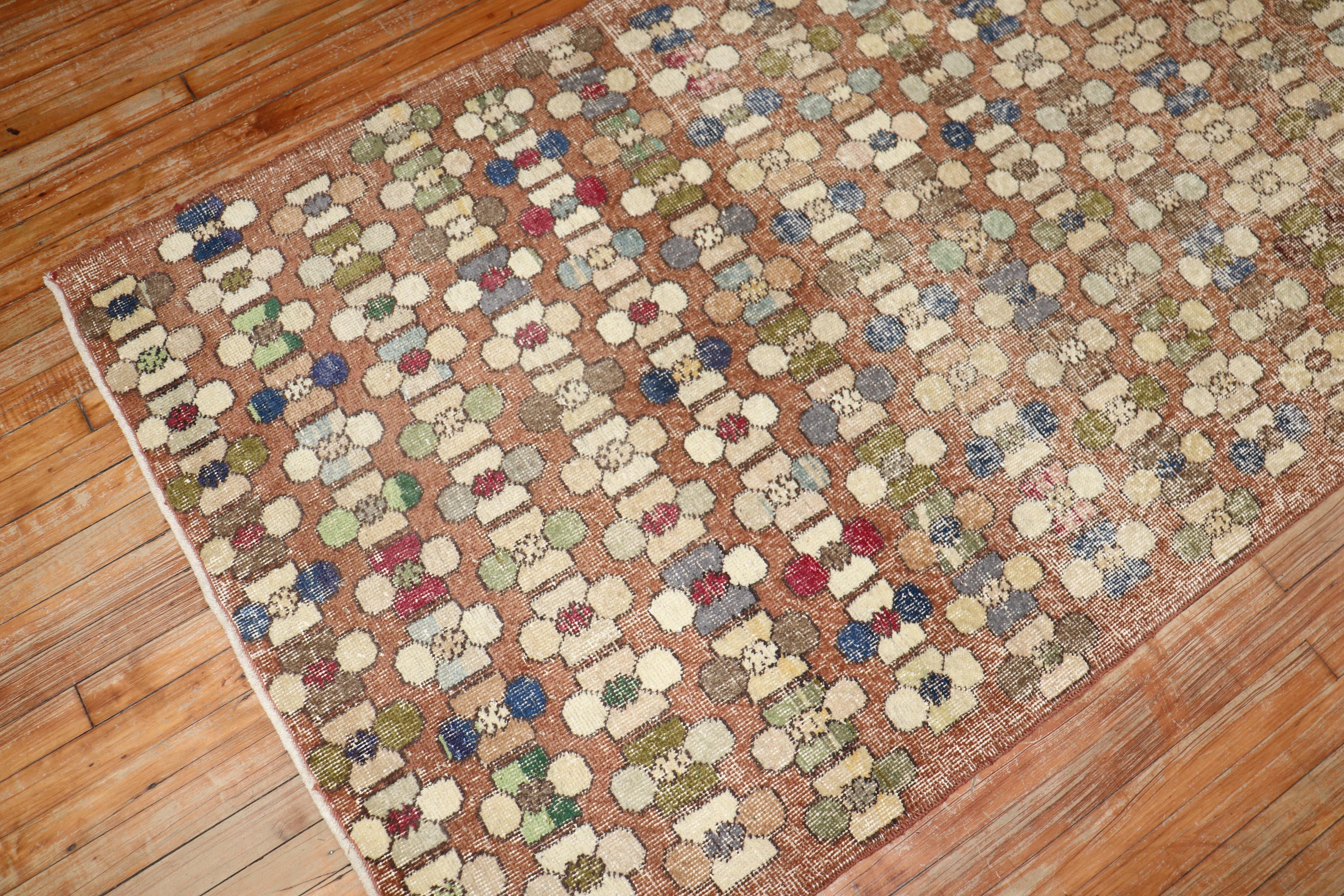 A vintage Turkish deco rug with an all-over borderless design in rustic tones. 

Measures: 3'10'' x 8'3''.