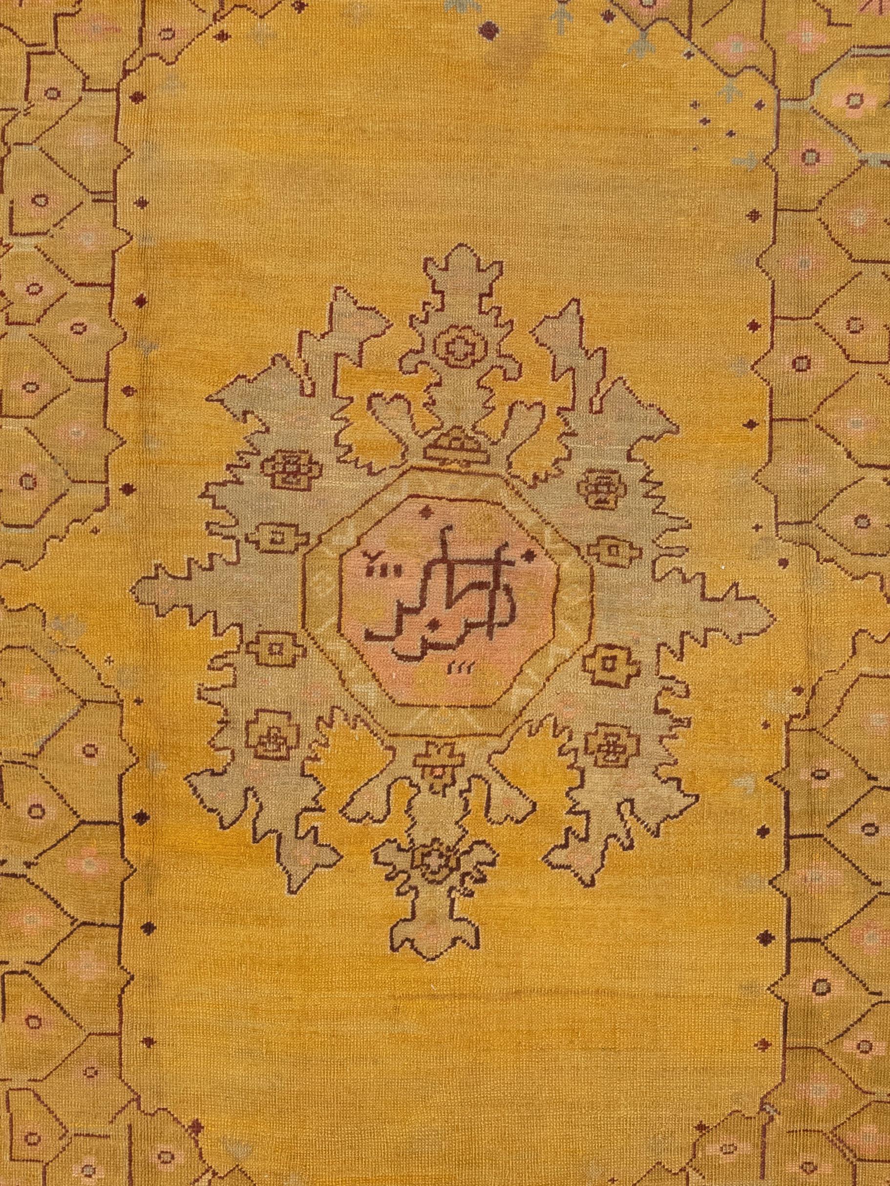 This is a Turkish Beaulieu Oushak Rug made in the 19th century. Oushak rugs originate from the city of Usak, Turkey and use a particular family of designs woven using dyes that lean towards: cinnamons, terracotta tints, gold, blues, greens, ivory,