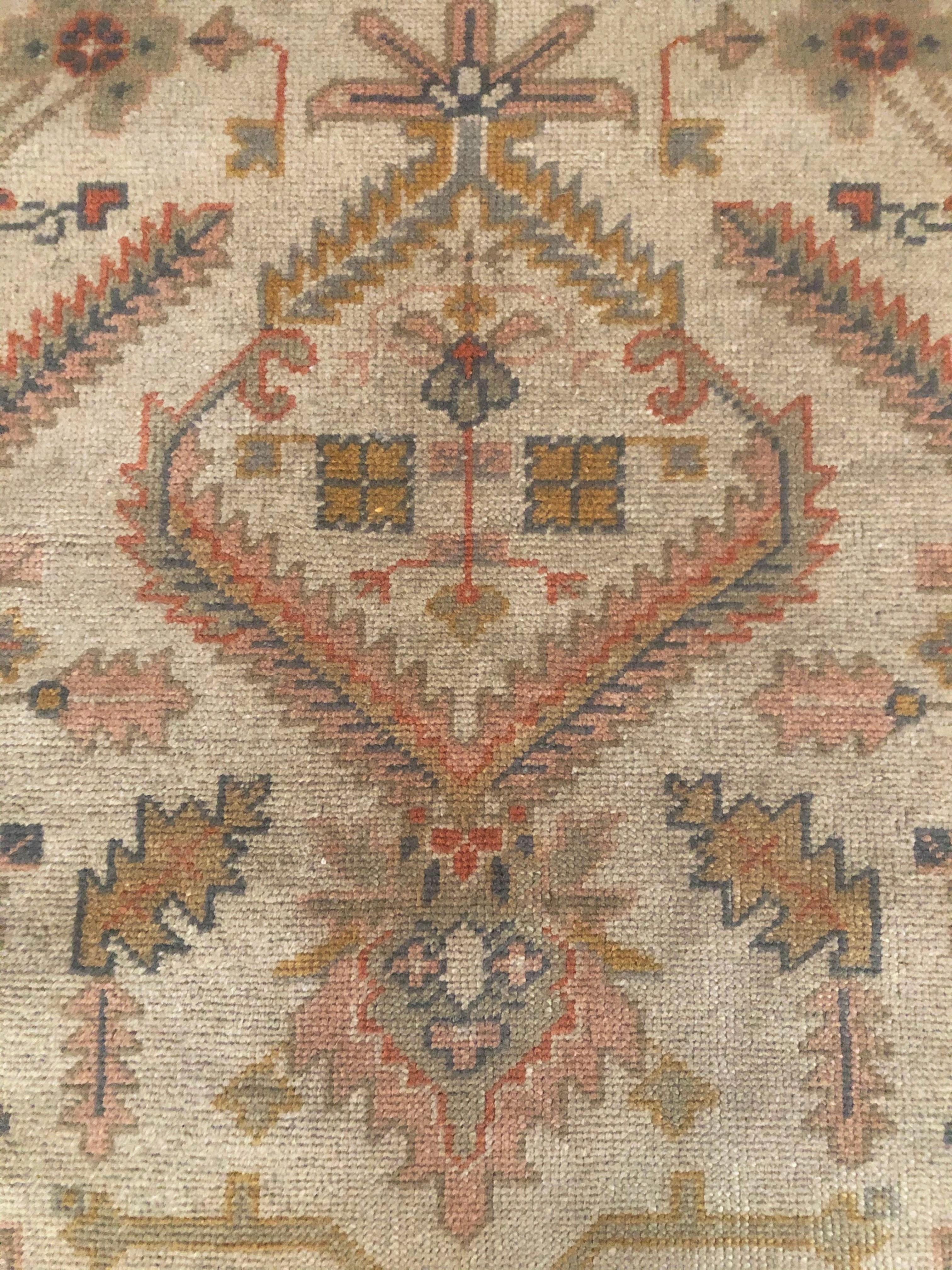 This is a Turkish Beaulieu Oushak rug made in the 19th century. Oushak rugs originate from the city of Usak, Turkey and use a particular family of designs that consist of dyes that lean towards: cinnamons, terracotta tints, gold, blues, greens,