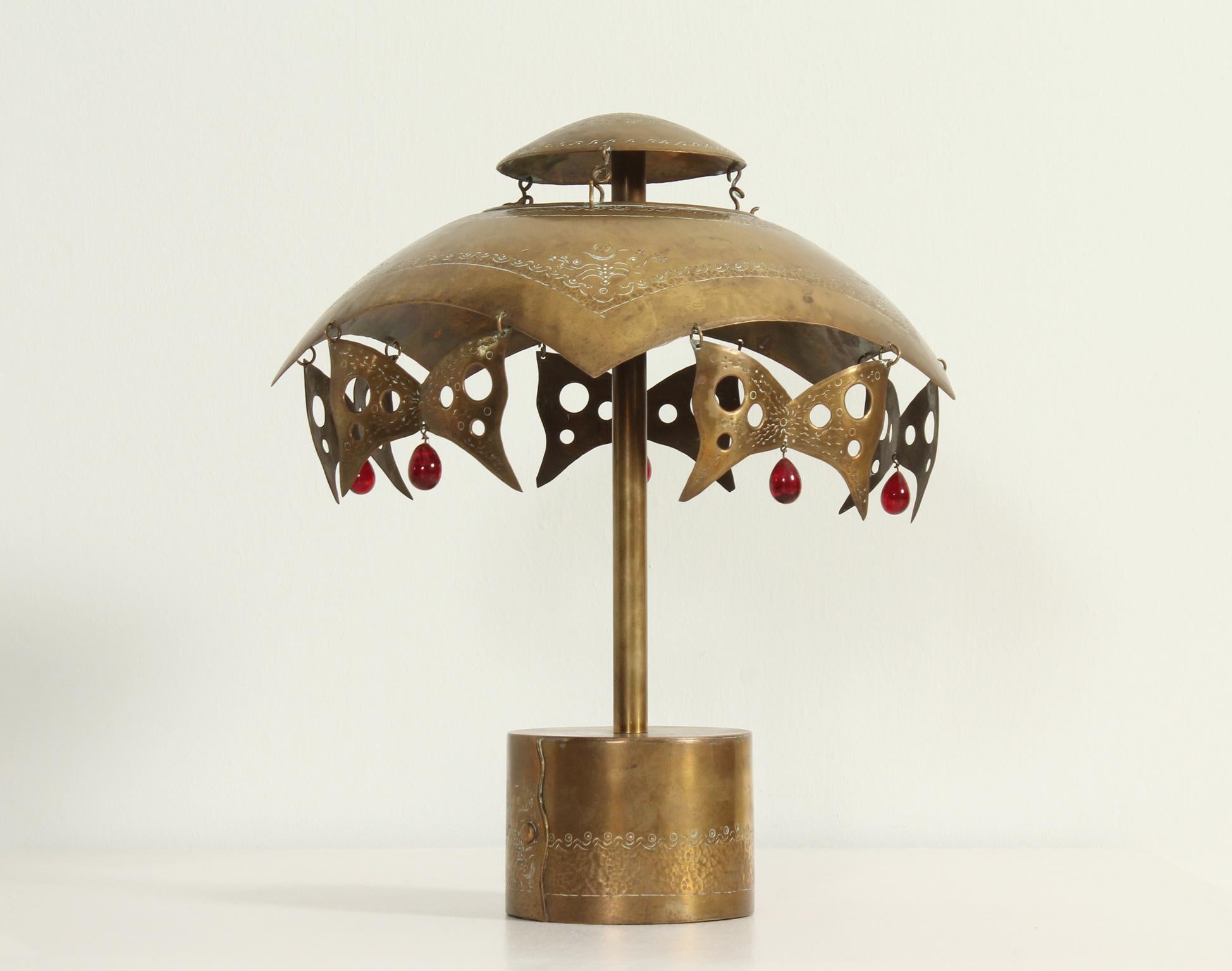 Turkish table lamp from 1950's. Embossed brass and colored glass beads. Nice effect of the reflection of the masks in the wall.
