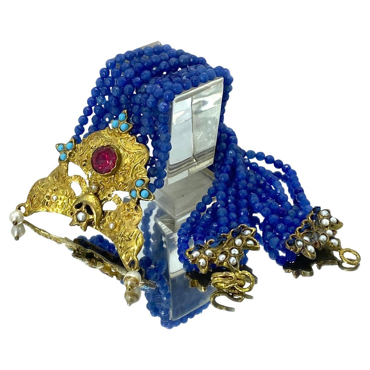 This multiple strand chrysophrase necklace with pendant comes from Turkey and has a vintage look. It was made with 4mm faceted blue chrysophrase beads. A gilt textured metal pendant with a large round cut ruby gemstone and some small pearls and the
