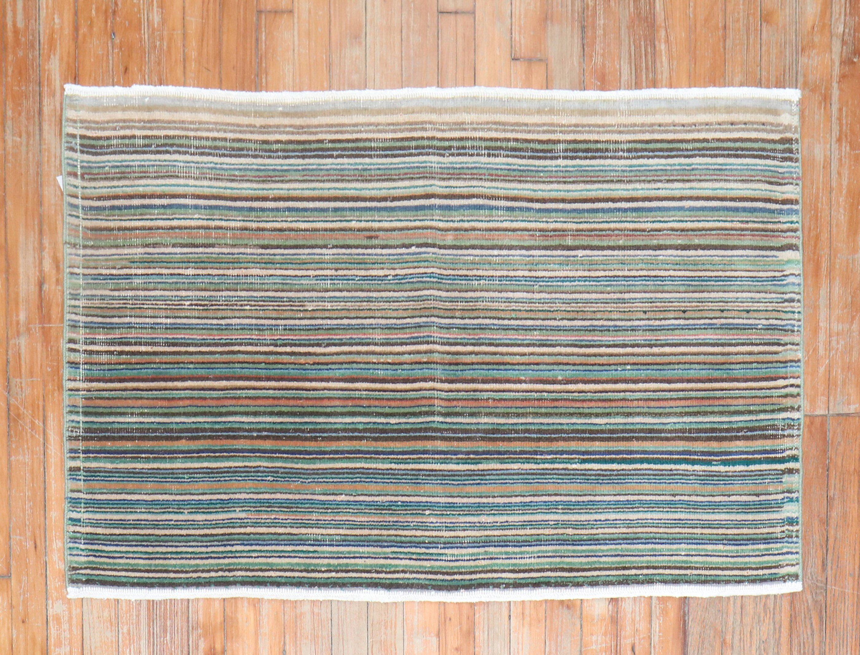 Mid-20th century Turkish Deco rug with a thin striped design.

Measures: 2'5''x 3'11''.