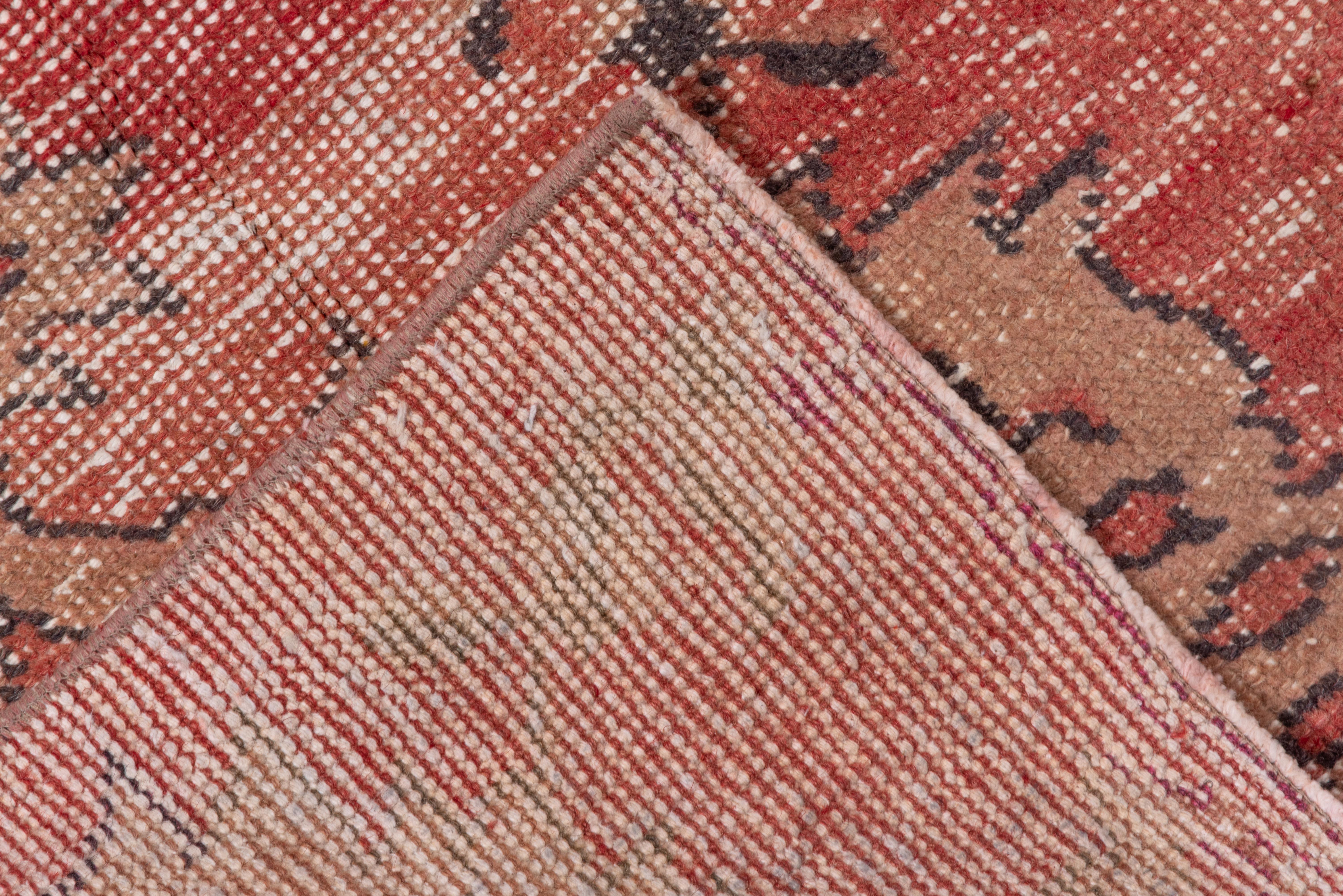 Turkish Faded Red Rug with Geometric Patterns Across In Good Condition For Sale In New York, NY