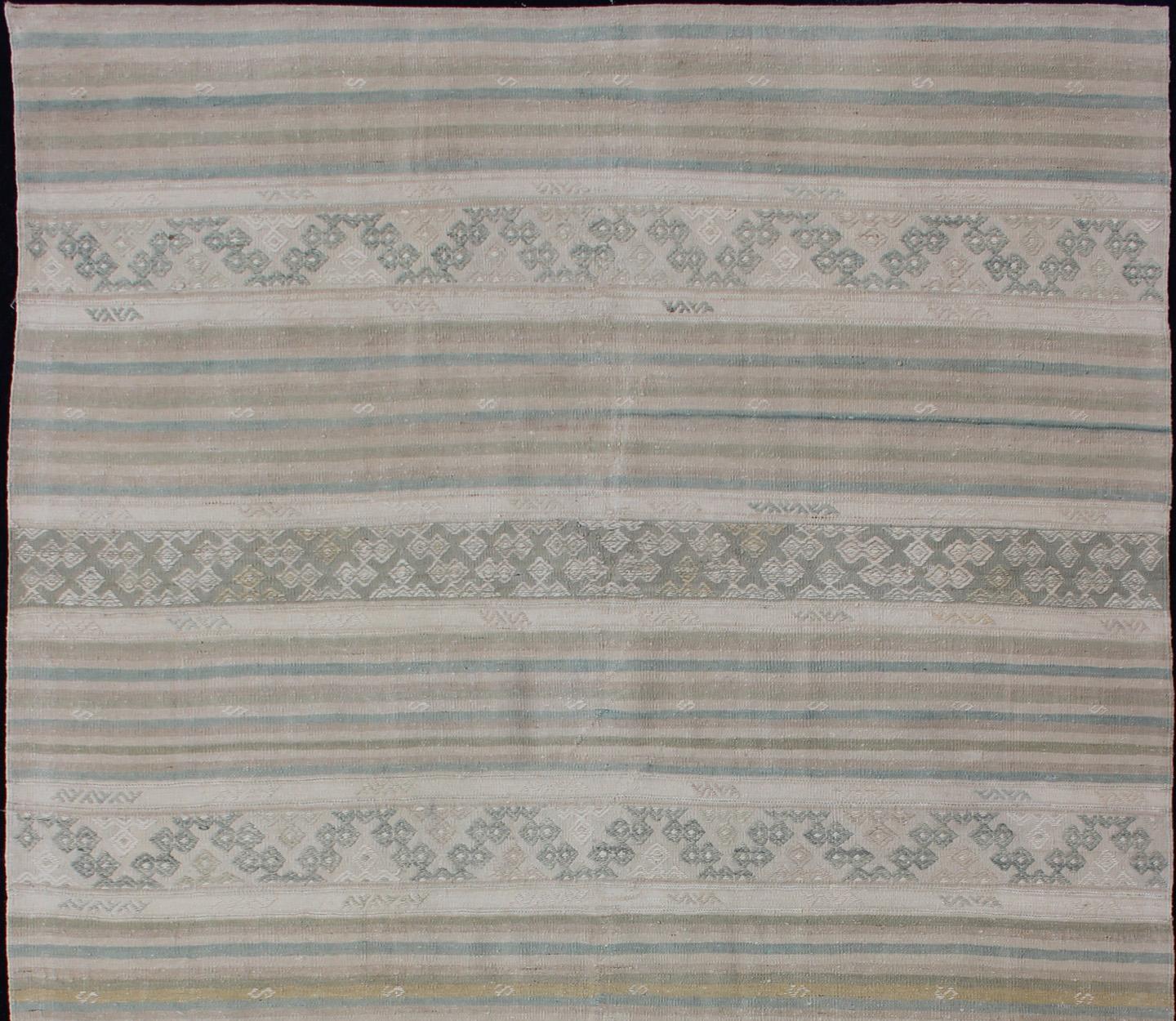 Turkish Kilim vintage carpet in light taupe, green, Tan, Light Brown, blush and, beige and cream, rug EN-179248, country of origin / type: Turkey / Kilim, circa 1950

This Kilim rug from Turkey features a striped design of various geometric patterns