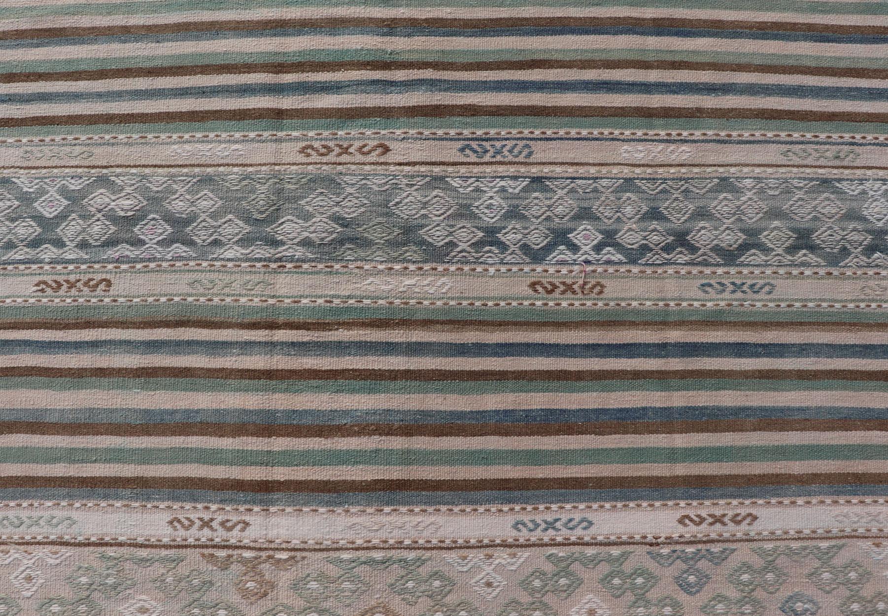 Measures: 5'7 x 9'9 
Turkish Flat-Weave Kilim with Stripes and Embroideries In Blue, Green, and Cream. Keivan Woven Arts / rug EN-13966, country of origin / type: Turkey / Kilim, circa 1950
This vintage Turkish Kilim rug features a contemporary
