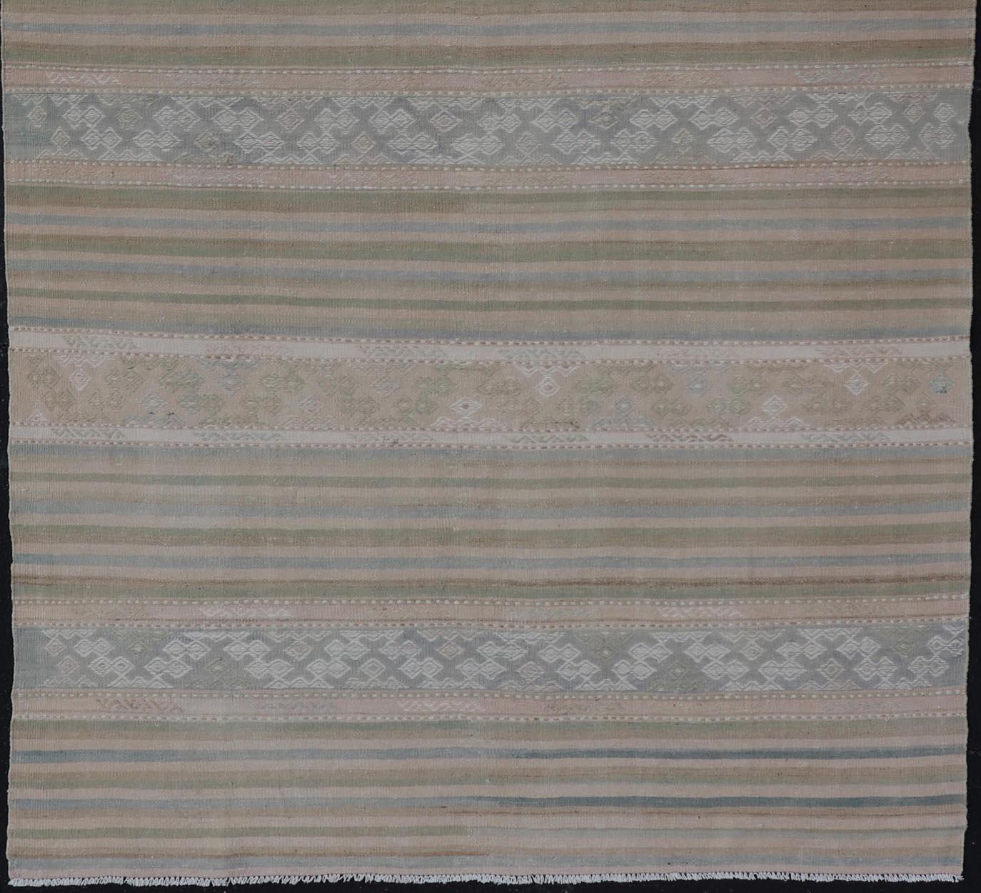 Measures: 5'2 x 10'1.

This charming vintage flat weave Kilim was hand woven in Turkey during the 1950s. Varying color combinations of muted shades of blue, pink, cream, green, as well as neutral shades like tans. Overall, this piece has held it's
