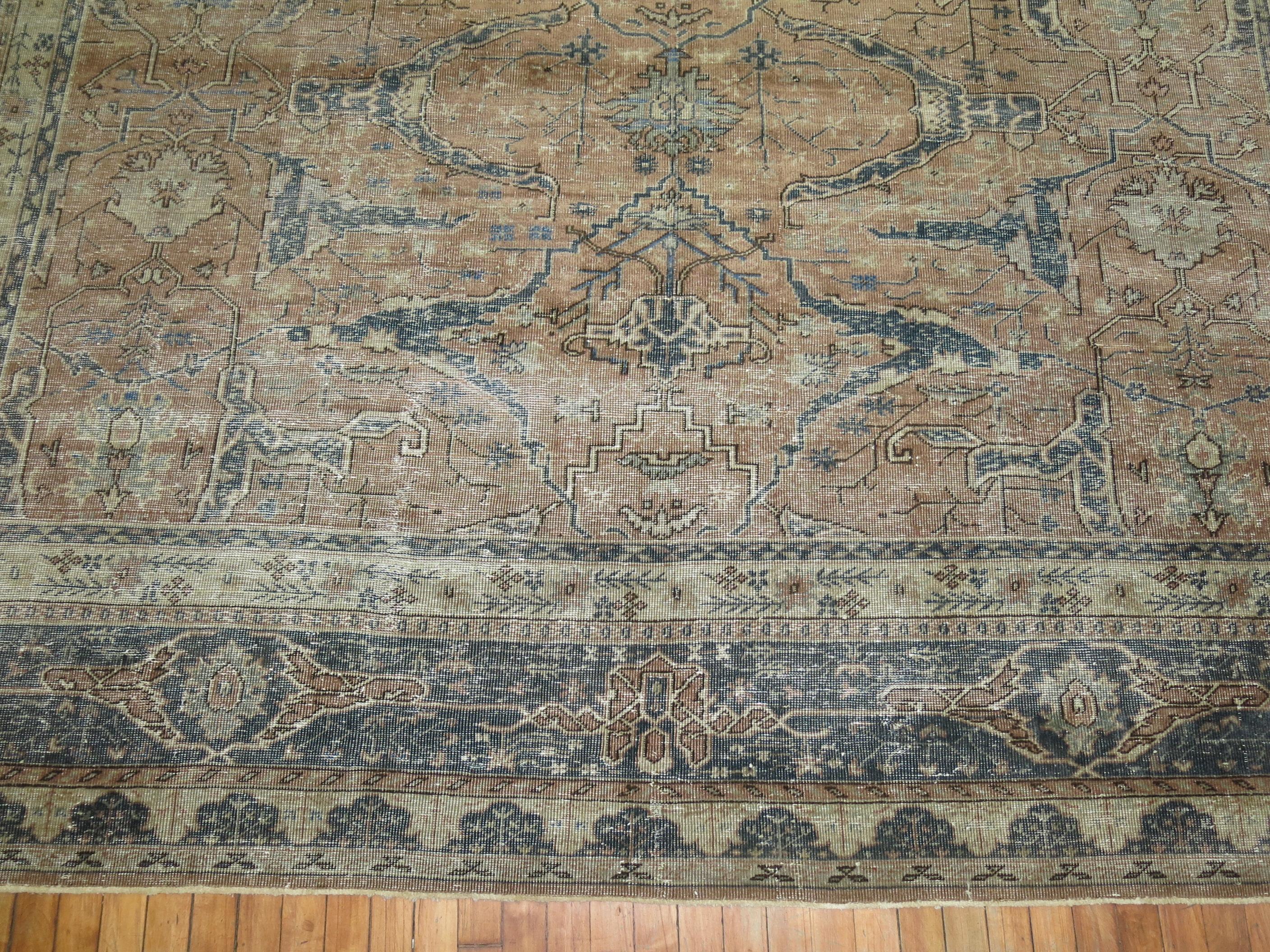 An evenly worn mid-20th century Turkish rug featuring an-all-over garrus design derived from 19th century Persian Bidjar rugs.