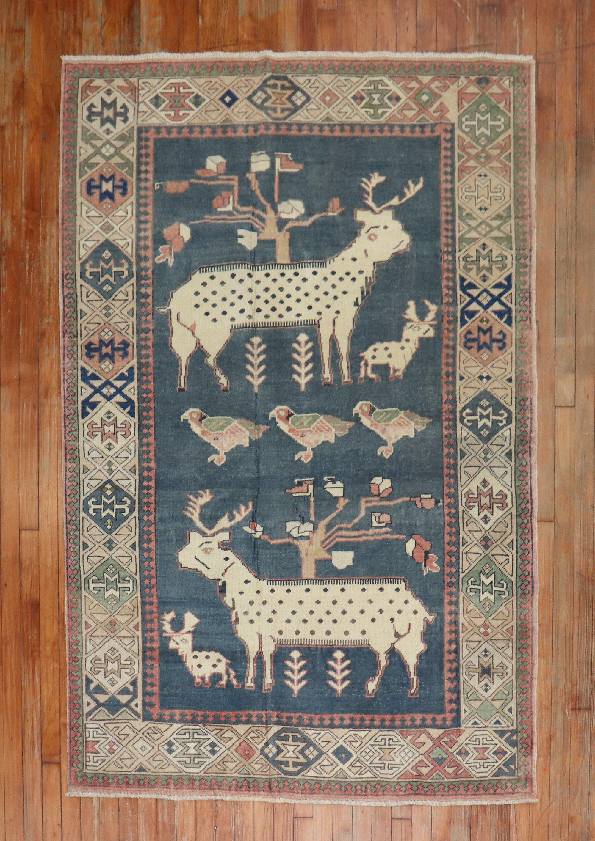 20th-century Turkish rug depicting 2 large goats, 2 small goats 3 pigeons on a charcoal ground

Measures: 4'7'' x 6'9''.