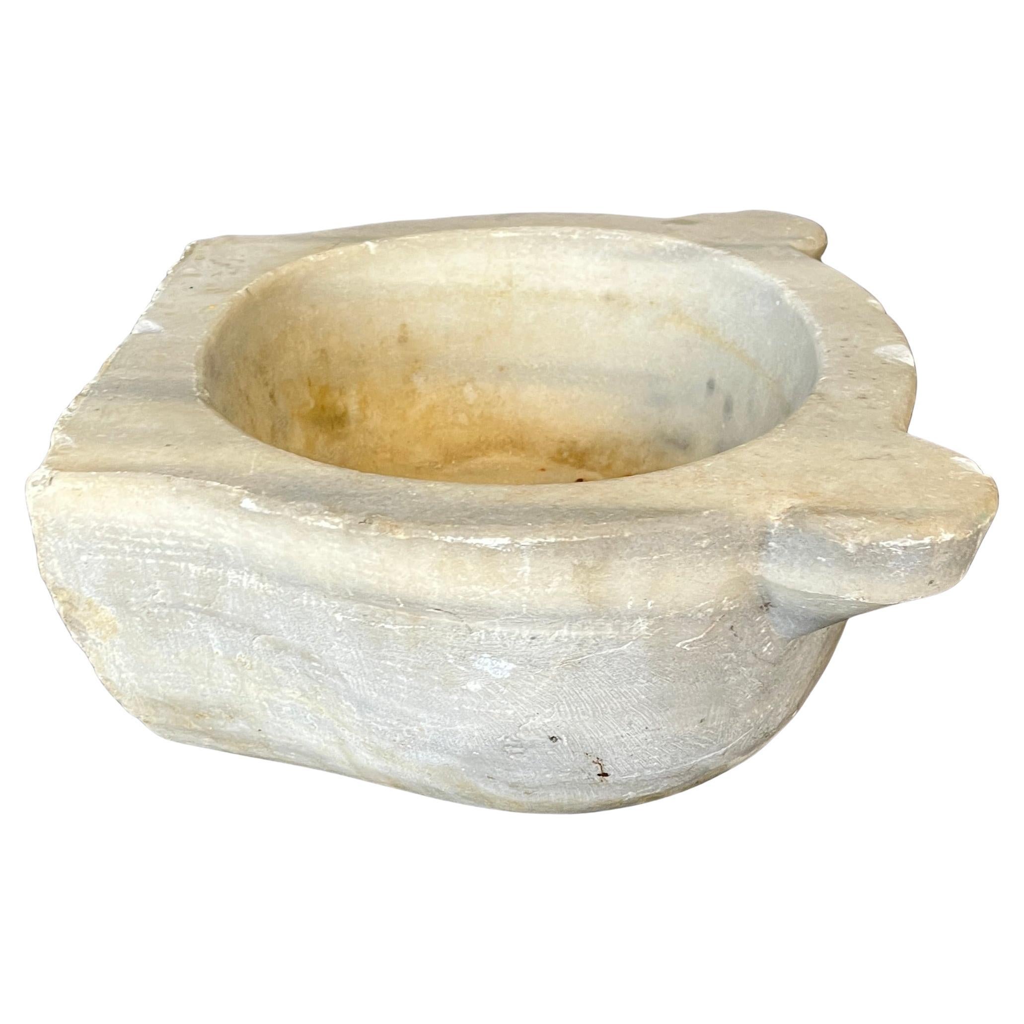 Turkish Marble Sink Crafted from solid marble, this elegant Turkish hammam sink exudes timeless sophistication. Its oval form, softened by years of use, is accented by two subtly protruding stabilizing wings—an architectural detail that nods to