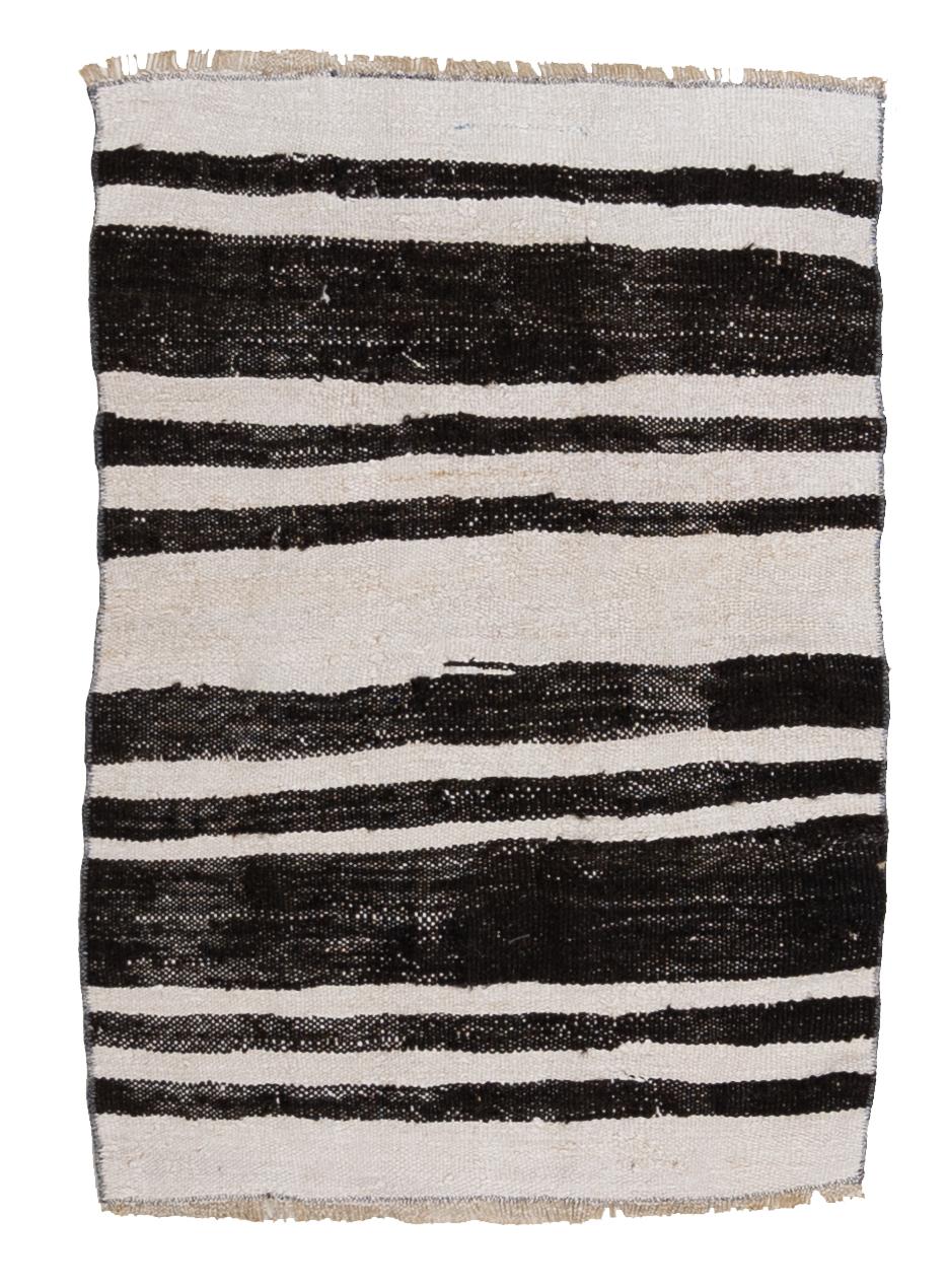 Age: Circa 1950

Colors: black, white

Pile: flatweave

Wear Notes: 1

Material: Wool on cotton. 

Wear Guide:
Vintage and antique rugs are by nature, pre-loved and may show evidence of their past. There are varying degrees of wear to vintage rugs;