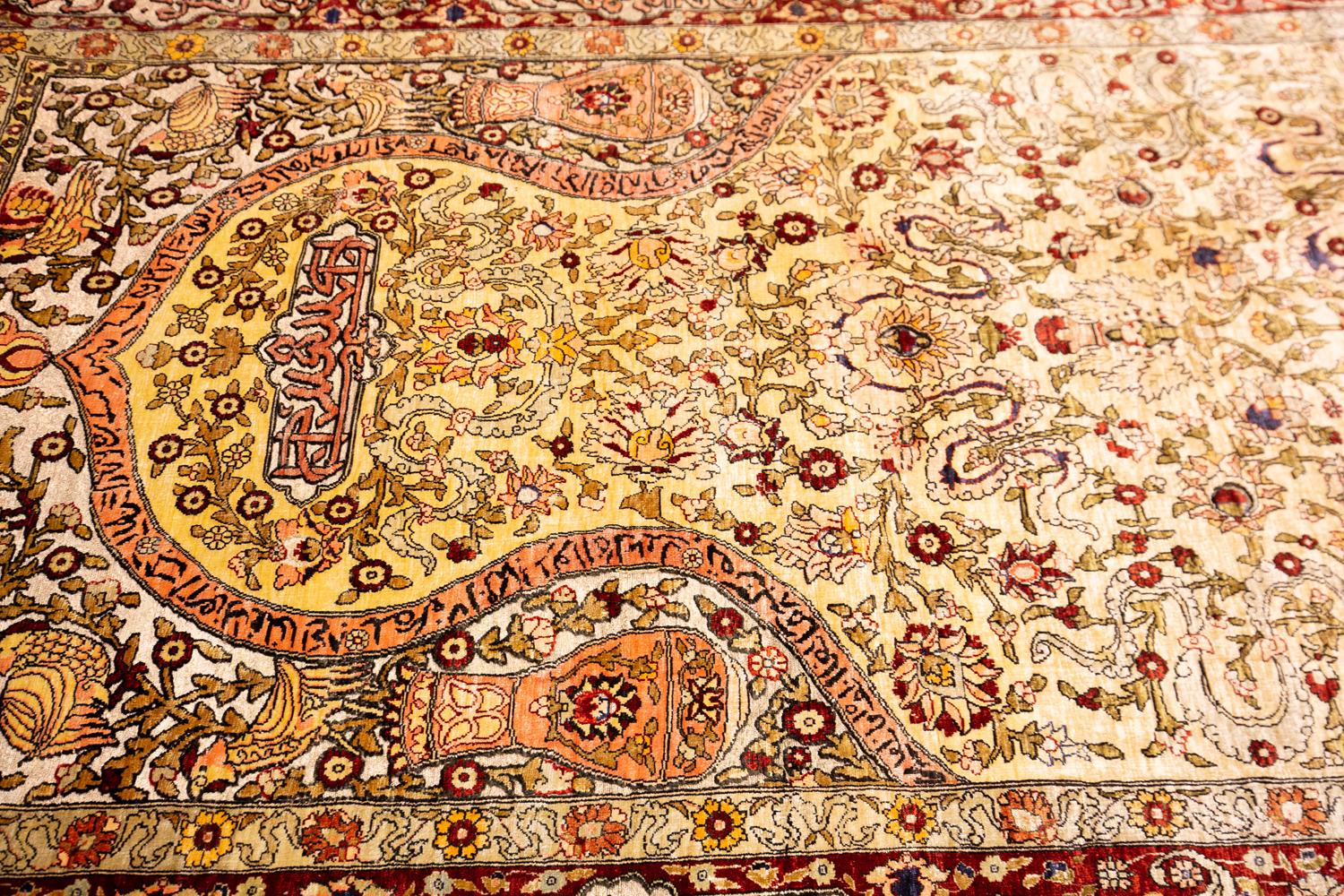 This is a silk souf Hereke with metal threads woven in Turkey during the fourth quarter of the 20th century and measures 157 x 98 cm in size. This rug has a mihrab design with scriptures from the Quran. The field is decorated with palmettes
