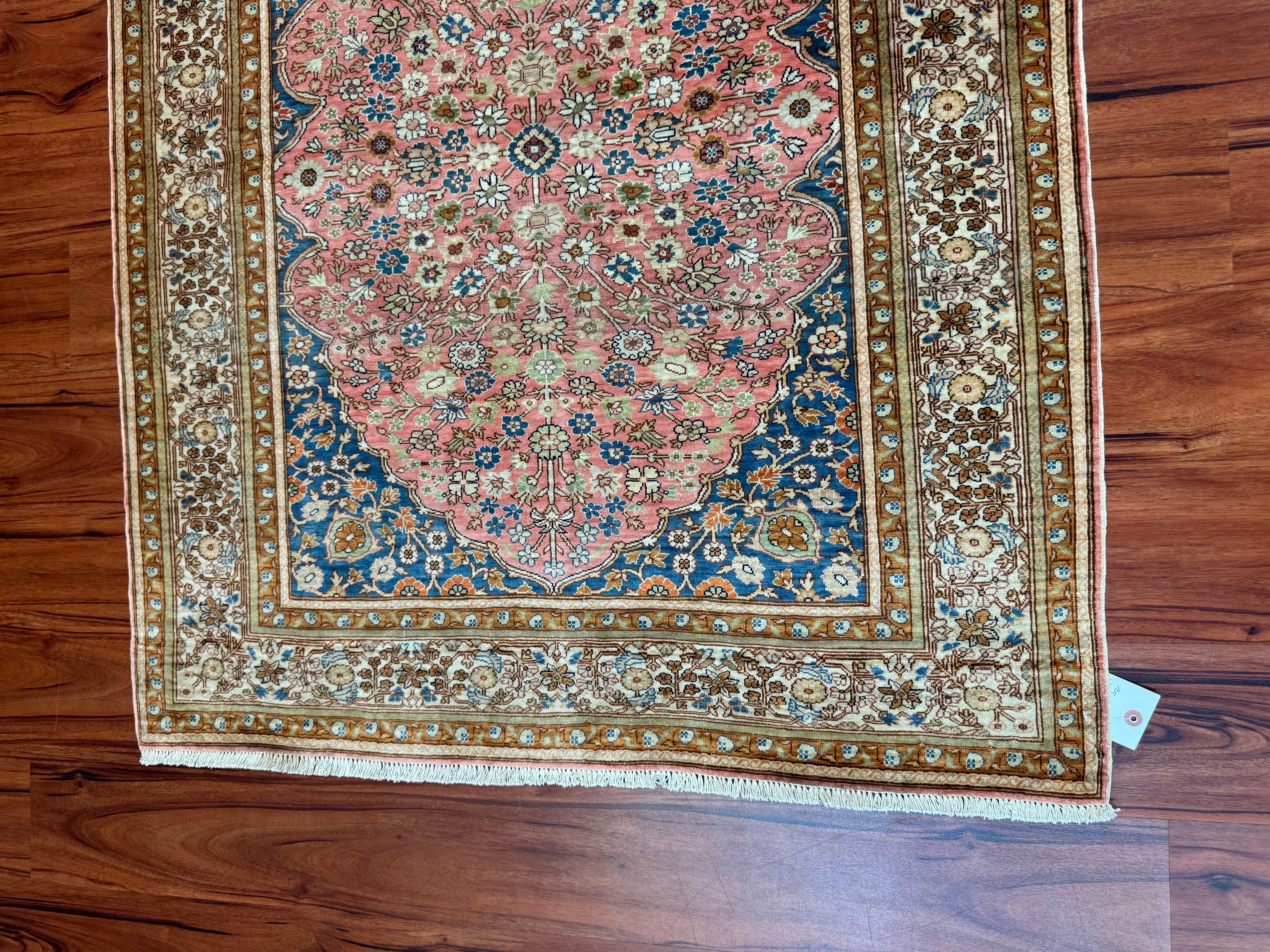 An absolutely stunning Turkish Hereke Silk Rug that originates from Iran in the late 20th century. This rug is in excellent condition and is made from 100% silk. The color combinations as well as the design make this rug truly gorgeous. 