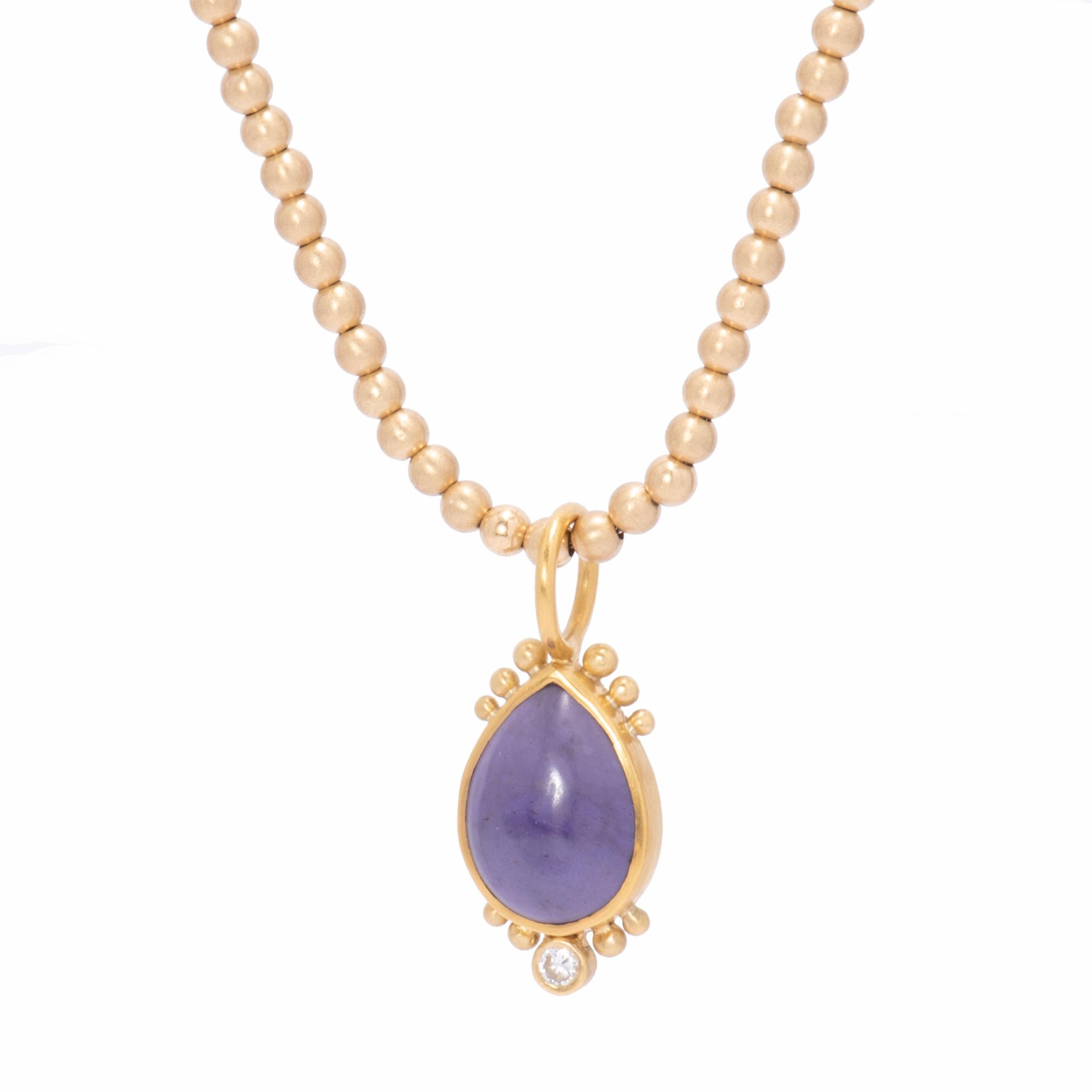 A natural, deep lavender pear shaped jade 6.71cts is set in 22k gold, crowned with beads and a single .10ct bright white diamond. Worn nestled at the throat or with a deep V neckline, the Turkish Jade Pendant is a softly beguiling adornment. Shown