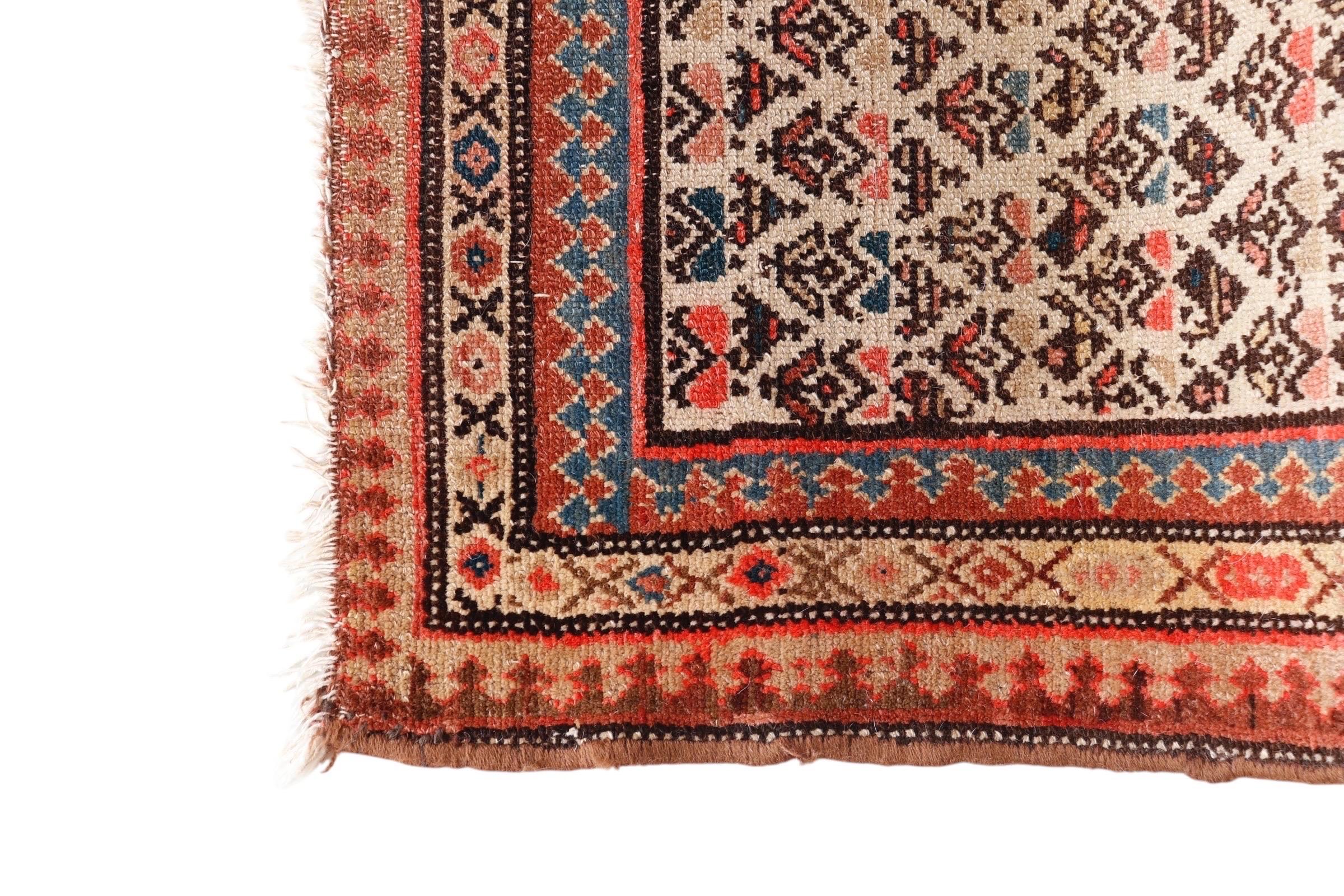 A Turkish Karabagh flat weave wool runner rug circa 1920. Hand woven in warm natural colors, the center is decorated with an all over geometric floral pattern in straight rows, surrounded with a triple banded border. The floral and tulip motif